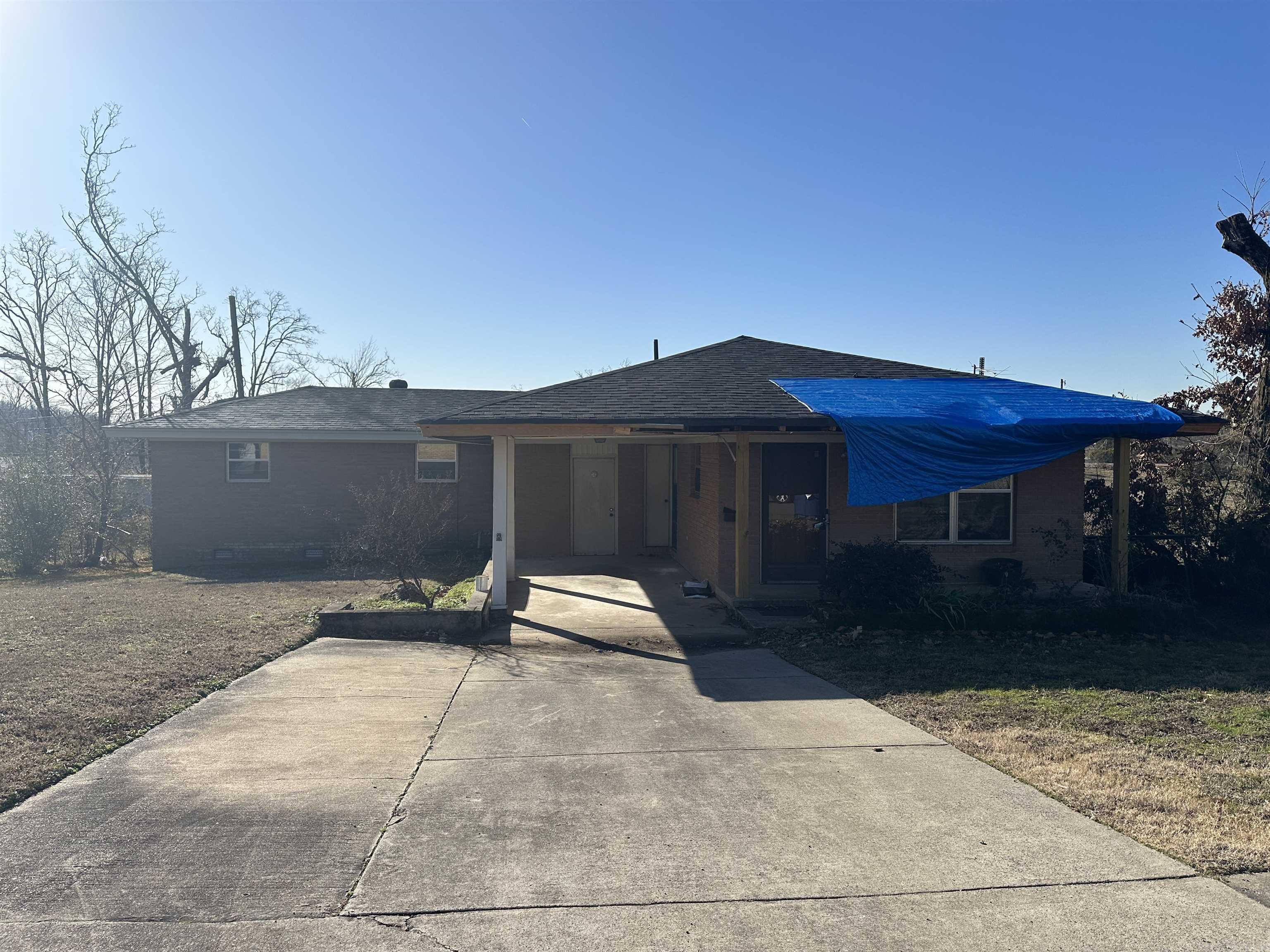 Super Cute Fixer Upper.  Perfect for Investor.  One Level Brick Home with Carport, Front Porch and Hardwood Floors.  Gas Cooktop, Home was damaged by tornado and is being sold AS IS with no repairs. Roof has been partially replaced. AC Condenser replaced in 09/2022.  Agents see remarks.