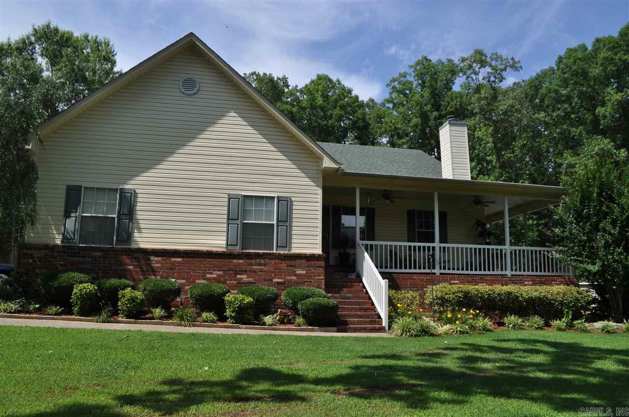 This beautiful home is tucked away so you feel like you are in the middle of the country. Landscaped yard with large wrap around porch, and the privacy surrounding the home and POOL. You will be welcomed by gorgeous NEW hardwood floors in the spacious living room with a gas log fireplace. Kitchen complete with freshly stained cabinets and a NEW gas stove.  NEW HVAC in May 2017. New Water Heater August 2017. New paint and trim throughout. 38X26 Shop with garage door and electricity. Call Today!!!