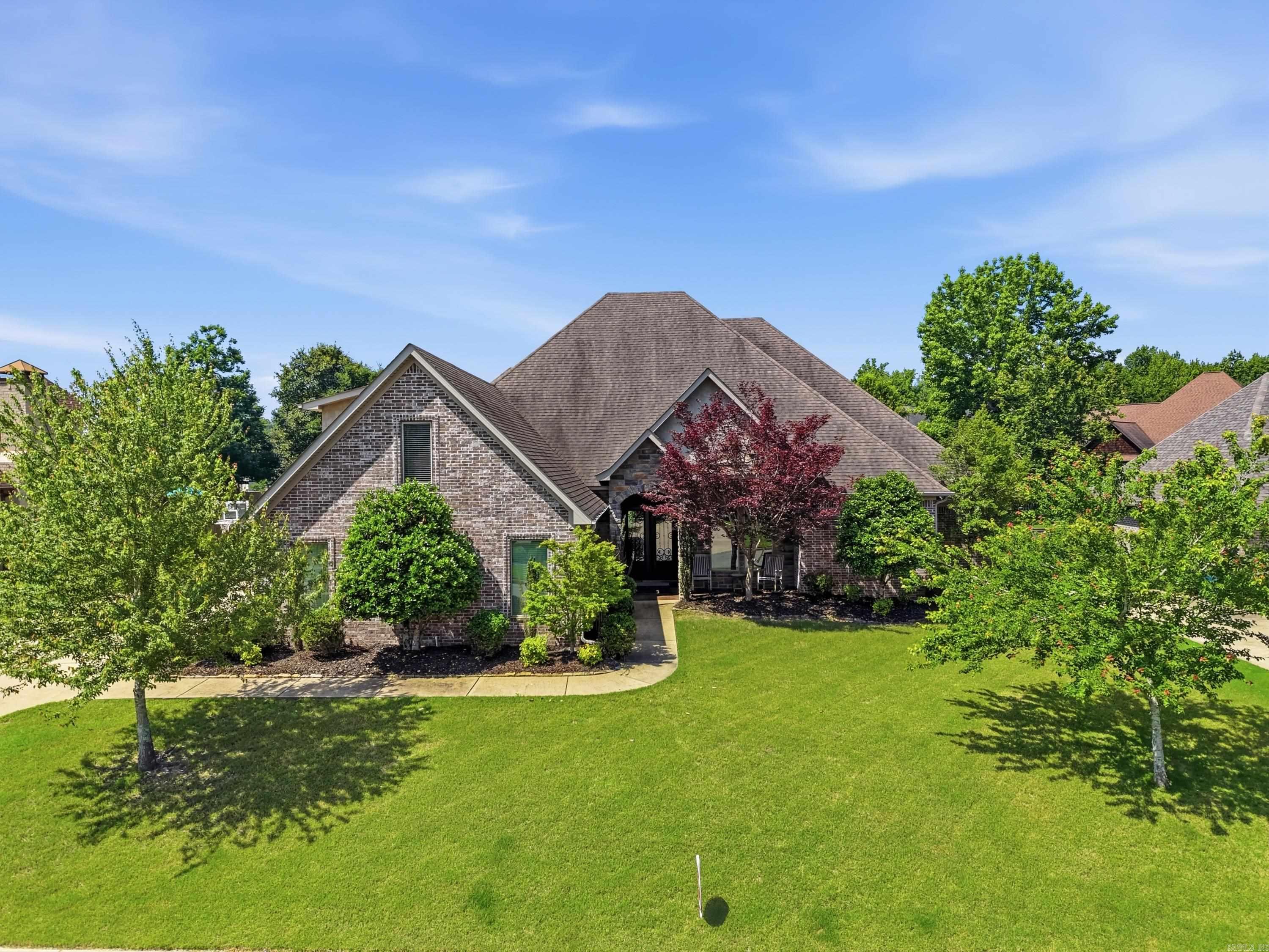 Wow! This one truly has it all. Located in the gated Westshore subdivision of Hurricane Lake Estates, this beautifully maintained home lives like a one level with all four bedrooms, an office, and 3.5 baths on the main level, plus a spacious bonus room upstairs and a 3 car garage. The open concept layout offers great flow and functionality, featuring a well-appointed kitchen that overlooks the living area. The primary suite is located apart from the other bedrooms and includes convenient laundry room access through the primary closet. Step outside to enjoy the large, covered patio with a fireplace and an extra-large, fully fenced, flat backyard. Situated on nearly half an acre, the property also offers beautiful lake views. Additional highlights include a new water heater, updated light fixtures throughout, new luxury vinyl plank flooring in the main living areas, and new tile flooring in the kitchen and primary bath. Don't miss this opportunity to own a move-in-ready home in one of the area's most desirable gated communities.