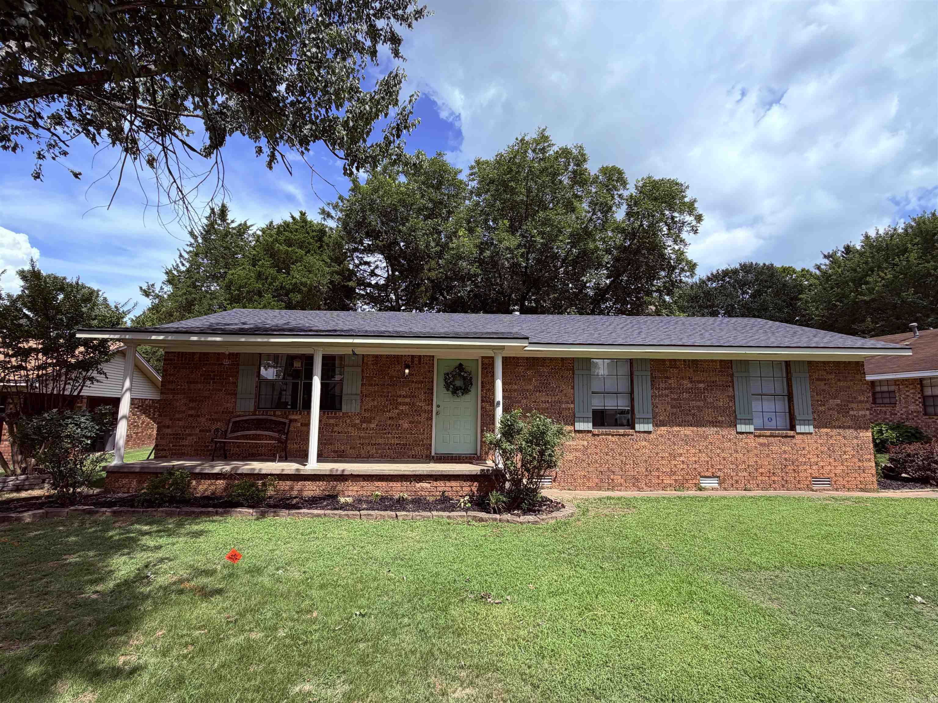 Move in ready 3 bedroom, 2 bath brick home with a new roof! This 1480 sq ft home offers custom cabinetry, an updated kitchen, a built in electric fireplace, and a functional layout. Hardwood, tile, vinyl, and carpet flooring provide character throughout the home. The backyard is fenced on 3 sides and includes an attached storage shed.