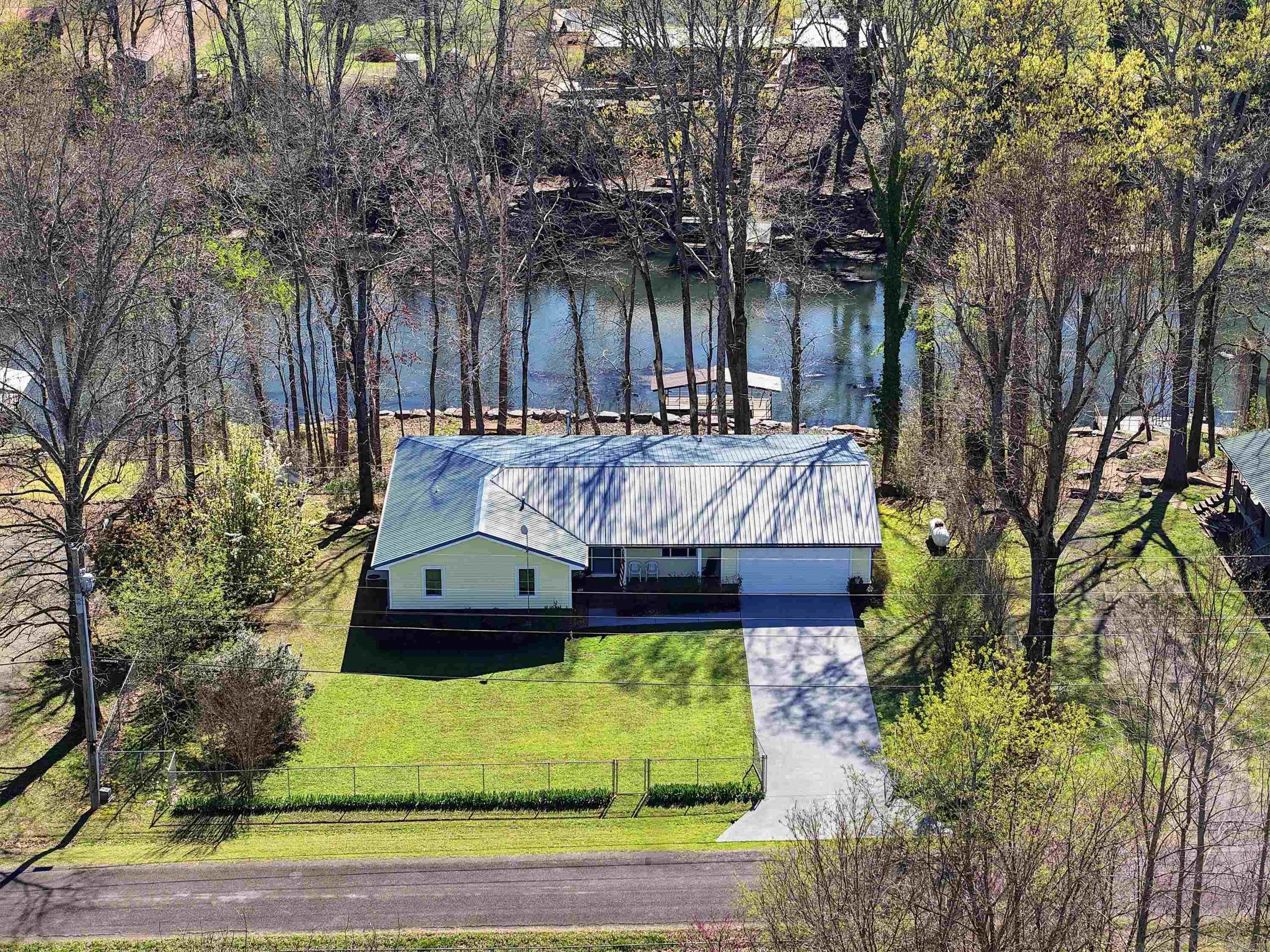 Welcome to 279 River Drive Estates in Pangburn, just steps from the famous Little Red River. This move in ready home is perfect as a full time residence, weekend getaway, or investment property. A major highlight is the approximately 850 square foot addition that significantly expands the living space and enhances the layout, creating a comfortable and inviting environment for family and guests. Inside you will find Hayes River Oak laminate flooring, quartz countertops in the kitchen and coffee bar area, all wood kitchen cabinets with soft close doors and drawers, Low E insulated windows, stain resistant carpet in the bedrooms, and tile flooring in the bathrooms. The home also features gas hot water heaters, a gas stove, central heat and air, and a cozy wood burning stove. Recent exterior updates include a new roof, vinyl siding, and custom rockwork on the riverside. The fenced yard includes a storage shed and room to enjoy the outdoors. With the Little Red River just steps from your backyard you can enjoy trout fishing and peaceful river living. No HOA in this neighborhood and short term rentals ARE allowed, making this an excellent Airbnb opportunity.
