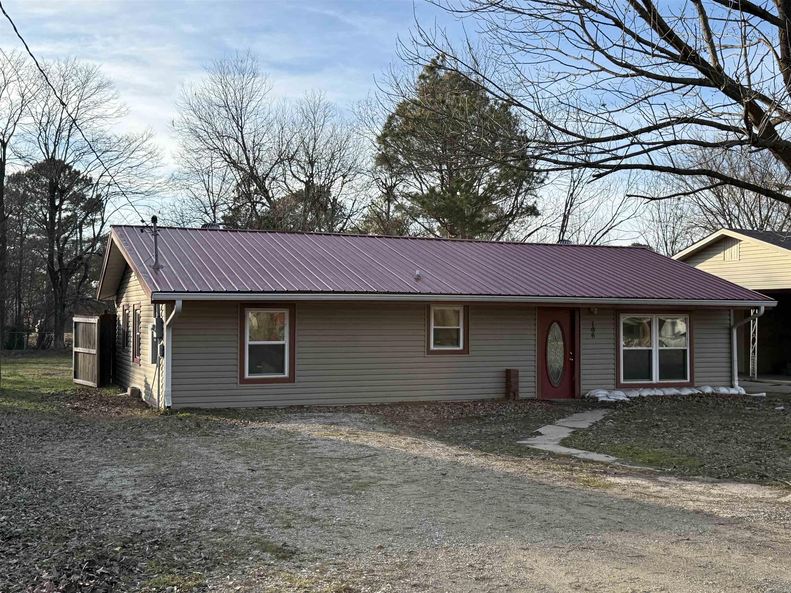 This three bedroom and one bath home offer 1,056sqft of comfortable living space with several key updates already completed. The property features a durable metal roof, LVP flooring, updated windows, and updated doors giving you peace of mind on major components. Outside, you will find a chain-link backyard that is perfect for pets or outdoor enjoyment, alone with a large shed that is wired for electricity. Gutters are already installed and the home sits on a quiet dead-end road with minimal traffic.   The home is being sold as-is. See agent remarks for additional details.   Schedule your showing today!