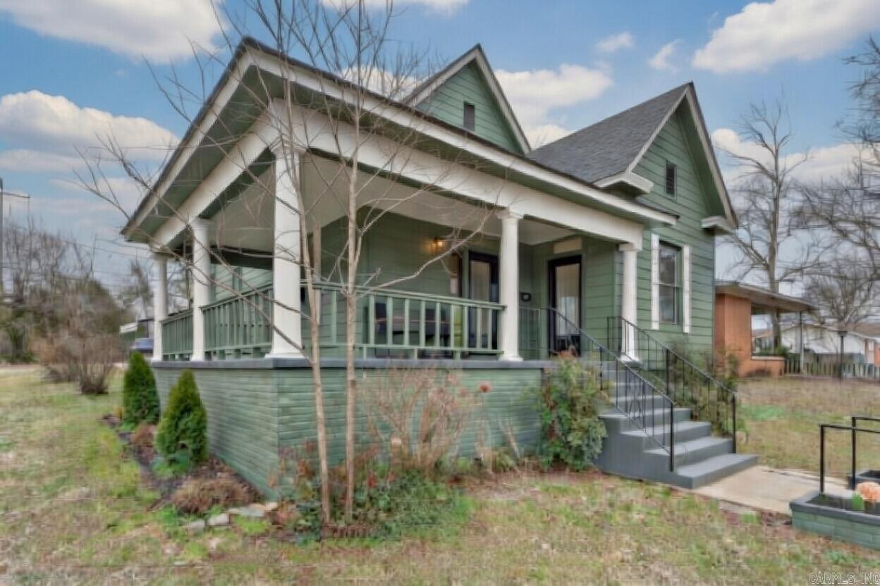 Discover timeless charm in this meticulously remodeled 1940’s Craftsman home—a perfect blend of vintage appeal and modern updates in the heart of Little Rock! Relax on the spacious front porch with morning coffee or summer BBQs. Inside, tall ceilings, refinished original hardwood floors, and abundant windows fill the space with natural light and warmth.  The flexible layout flows seamlessly: front guest bedroom/office, generous living room for any furniture setup, versatile formal dining (ideal as primary suite alternative), front guest bath for convenience, and private bath toward the back. Enjoy extra storage in the separate laundry room plus another guest bedroom/office for endless options. The spacious kitchen delights with ample cabinets, granite countertops, farmhouse sink, and room for a cozy breakfast nook.  Private backyard parking includes covered parking pad. Major recent updates: new floors, roof, HVAC, kitchen, bathrooms—truly move-in ready! Prime spot minutes from UAMS, Children’s Hospital, and Downtown Little Rock.