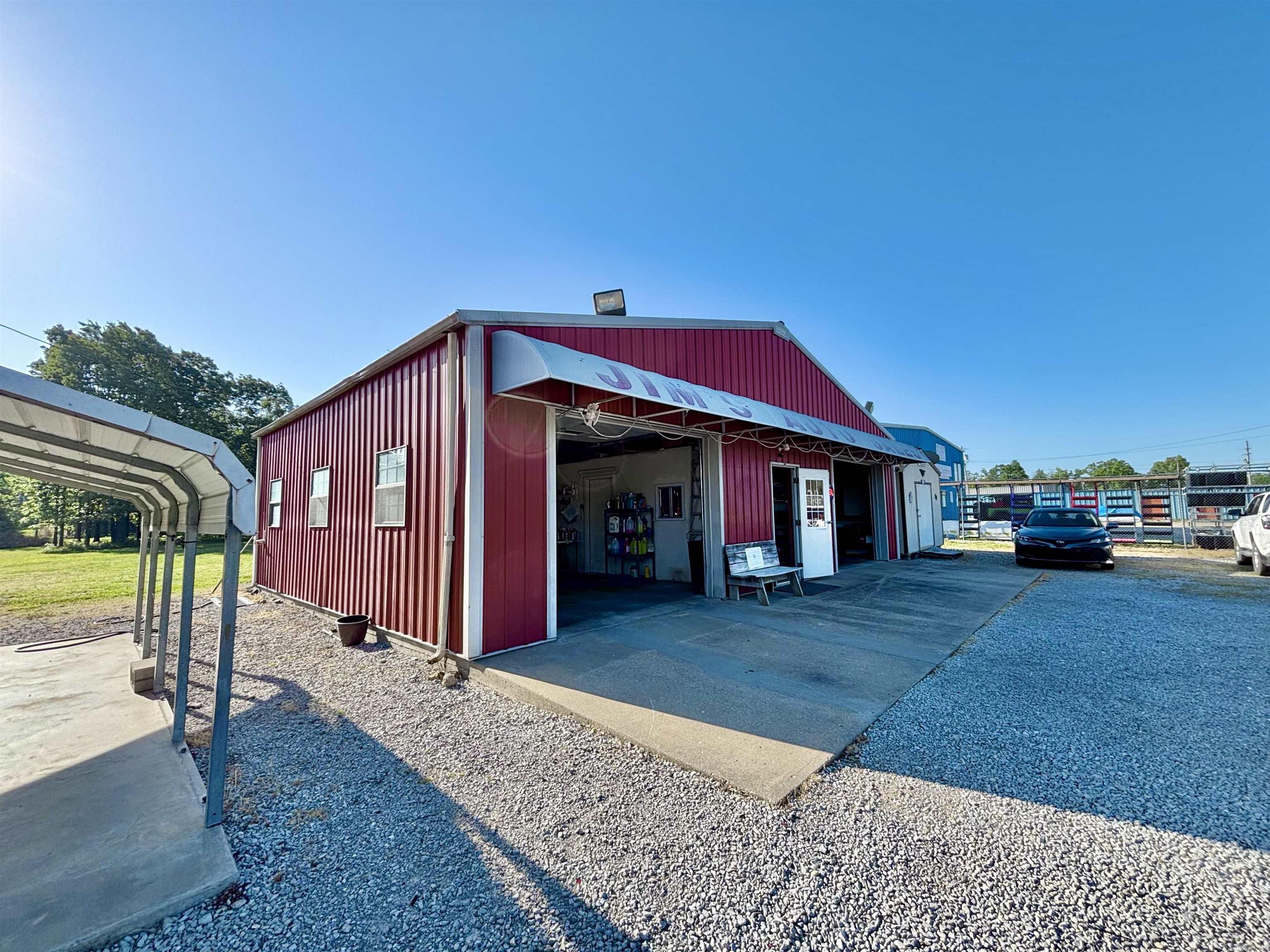 1.57-acre +/- property on Highway 62/412 in north-central Arkansas-- a standout opportunity for a wide range of thriving business ventures!!! With excellent visibility, steady traffic, and easy access, it’s perfectly positioned for retail, service, automotive, or contractor-based operations to succeed. With over 40 years as a successful used car lot, this location has a proven history of strong performance and high exposure! The property features a 30x40 commercial building with office space, bathroom, and garage, along with a 14x28 Bald Eagle Barn—ideal for storage, workspace, or future expansion. The level, open acreage offers plenty of room for parking, additional buildings, or scaling your business as it grows. Utilities are available and nearby, making future expansion or even building a new home convenient and cost-effective! Whether you’re starting fresh or expanding, this property delivers flexibility, visibility, and long-term potential in the booming Ozarks region! (**Lot lines in listing photos are approximate.**)