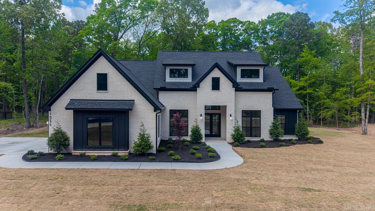 WOW!!! Stunning New Construction Home Nestled on a Tree Shaded 1 +/- acre  Lot... Amenities include: Approximately 3344 Square Feet, 4 Bedrooms, 3 1/2 Bathrooms, Living/Dining Combo, Kitchen/Dining Combo, Open Floorplan, Split Bedroom Floorplan, Dream Kitchen with ample cabinets, large Kitchen Island, Oversized Pantry, Built in Gas Range with Pot Filler, Double Wall Ovens, Microwave, Large Living Room with Gas Log Fireplace, Mudroom, Laundry/utility Room, Office, Nice Primary Bedroom, Large Walk-In Closet with Built-in Dressers, Custom Tile Shower with Stand alone soaking tub, all bedrooms have walk-in closets, Pella ( slider ) Windows throughout home, Private Covered Rear Patio with Fireplace overlooking private, serene back yard, Extra Landscaping, Sprinkler System, Gutters, 3 Car Side Loaded Garage, Bryant Schools, And Much More... This is a Must See Custom Home with no details left out...