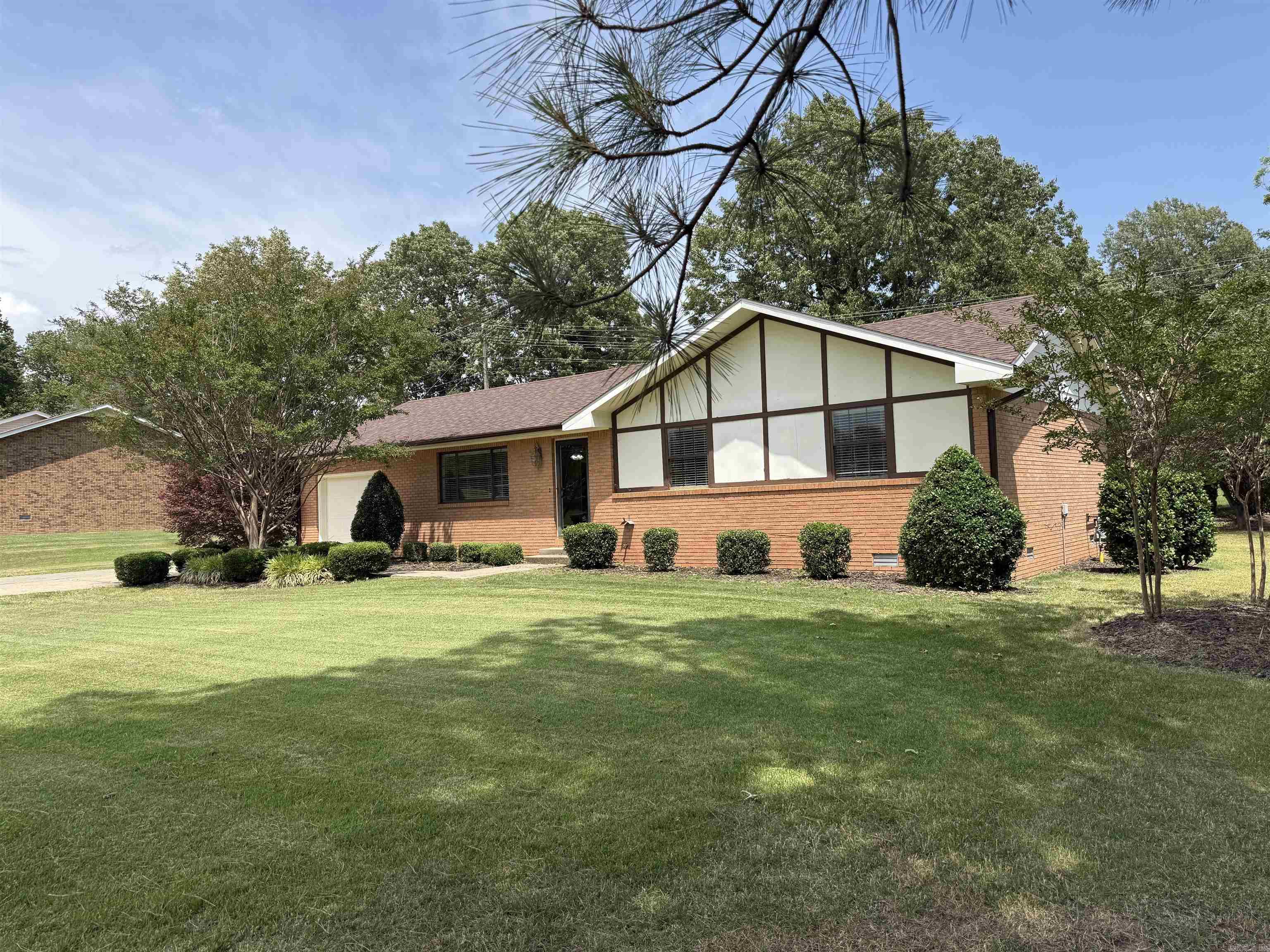 Welcome to this immaculate move-in-ready 1269 sq ft , 3 bedroom, 1.5 bath brick home offering, comfort, convenience, and beautiful curb appeal. Inside, you'll love the open-concept living and dining area filled with natural light and designed for easy everyday living and entertaining. The spacious laundry room adds extra functionality, while the well-mainitained interior makes this home truly turnkey.   Step outside to enjoy a covered patio perfect for relaxing mornings, outdoor dining, or quiet evenings at home. The beautifully landscaped yard enhances the home's inviting atmosphere, and the attached garage provides additional storage and convenience.   Ideally located near the local town square, hospital, schools, community park, and the famous Hemingway-Pfeiffer Museum and Educational Center. This home offers small-town charm with easy access to everyday amentities.  Don't miss your opportunity to own this beautiful home just listed! Immediate possession is available upon closing. Don't wait! Call today to see this incredible home!
