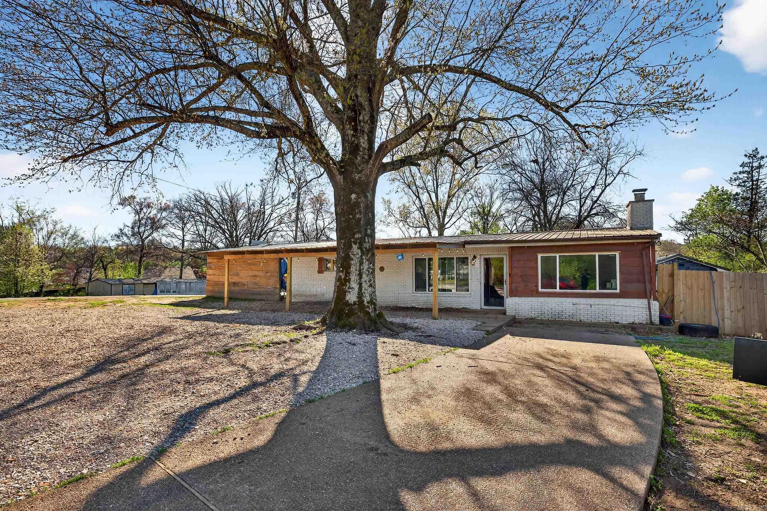 This beautifully updated three-bedroom, two-bath home is located just outside of Hot Springs in the highly desirable Lake Hamilton area—only a minute from the lake. Offering the perfect blend of comfort and convenience, the home features numerous updates throughout, including a new carport, fresh flooring, and modern finishes that give it a refreshed and inviting feel. The spacious layout is ideal for both relaxing and entertaining, while the fenced-in backyard provides a private outdoor space perfect for pets, children, or weekend gatherings. Whether you're looking for a primary residence, vacation home, or investment property, this charming home offers incredible potential in a prime location near one of Arkansas's most sought-after lakes.