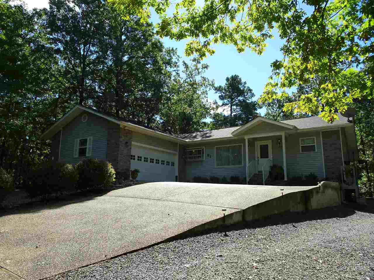 Charming home in a private wooded setting.  Open plan with vaulted ceiling, and laminate plank flooring throughout.  Cozy gas fireplace, stainless appliances, abundant cabinetry, sun room, & large laundry room, that can accommodate a computer area. Outdoors, you'll love the relaxing covered deck, fenced yard, and drip irrigation system for your gardens.  A comfortable place to call Home!