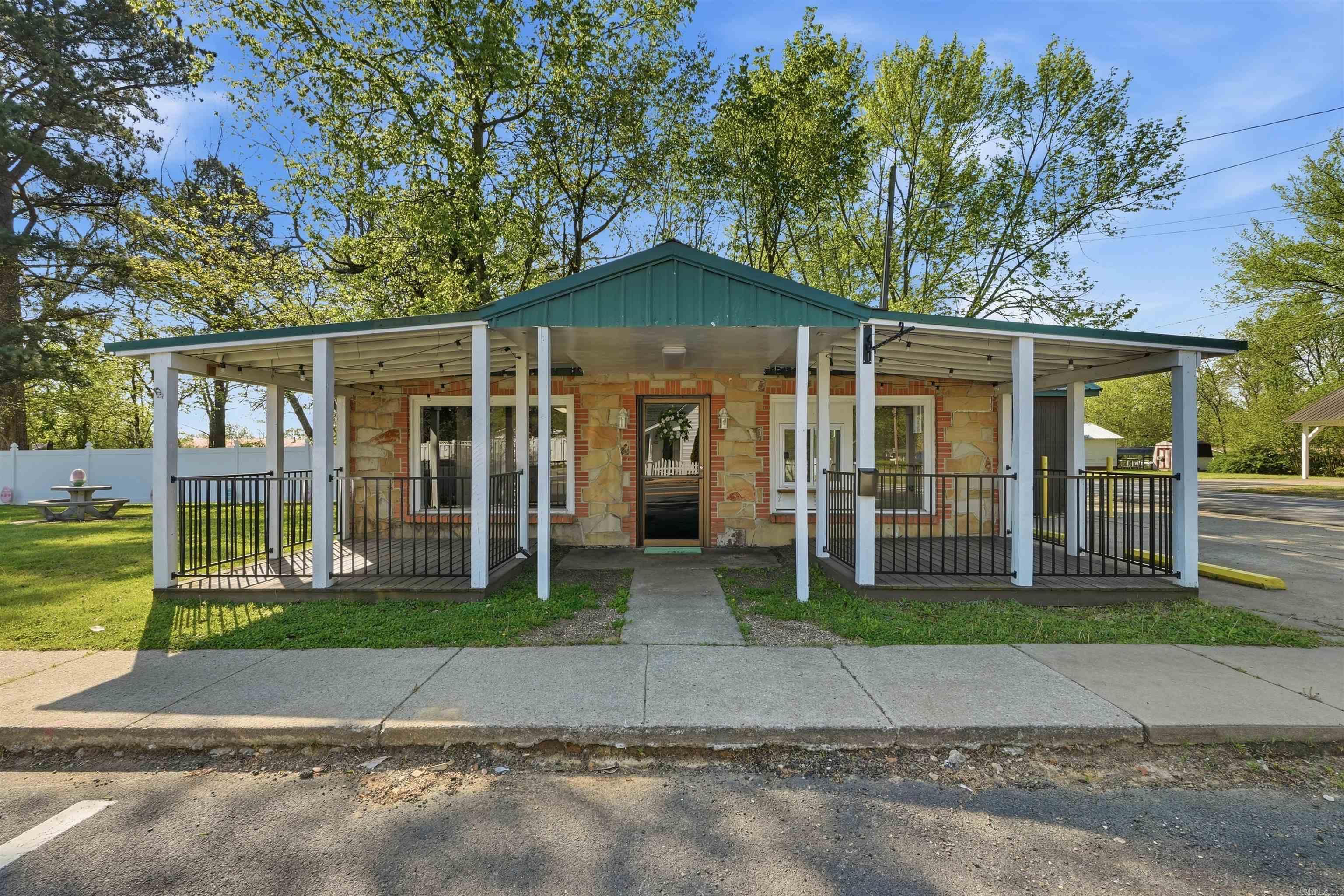 Welcome to 900 Main Street in the heart of Pangburn! Positioned on a prime corner lot in the downtown area, this charming property offers incredible visibility and versatility for your next venture.  The building features a welcoming exterior full of character with a large covered patio with a walk-up window, making it an ideal setting for a restaurant, café, or boutique business. With its layout and location, it also presents a unique opportunity to be repurposed into a highly desirable short-term rental or Airbnb.  Located just minutes from the world famous Little Red River and Dripping Springs Access, this property is perfectly positioned to attract locals and visitors alike—especially those coming to enjoy some of the best trout fishing in North America.  Whether you’re an entrepreneur looking to establish a business or an investor seeking a short-term rental opportunity in a growing recreational area, this property offers the perfect combination of charm, location, and potential. Recent updates have been made and new plumbing installed in multiple areas.  Agents, see remarks.
