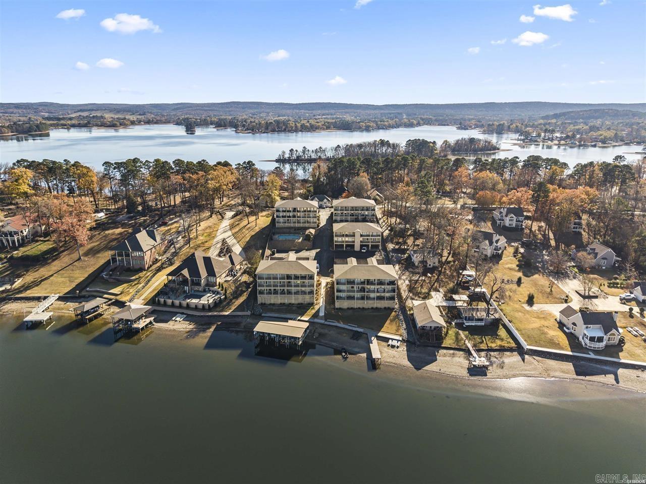 Move-in ready lakefront condo in Hot Springs Arkansas on Lake Hamilton featuring 2 bedrooms, 2 baths, and approximately 1,520 sqft with covered carport parking and beautiful lake views in gated community with a pool. This updated Lake Hamilton condo for sale in Hot Springs, offers new flooring, granite countertops, and a functional layout, making it an ideal full-time residence or low-maintenance lake retreat close to Oaklawn Racing Casino Resort and downtown Hot Springs.  Enjoy low-maintenance lakefront property with quick access to dining, shopping, and entertainment while living in a gated lakefront community on one of the Arkansas' most popular recreational lakes. Washer and dryer stay, rentals 30 day minimal, ice machine is new.