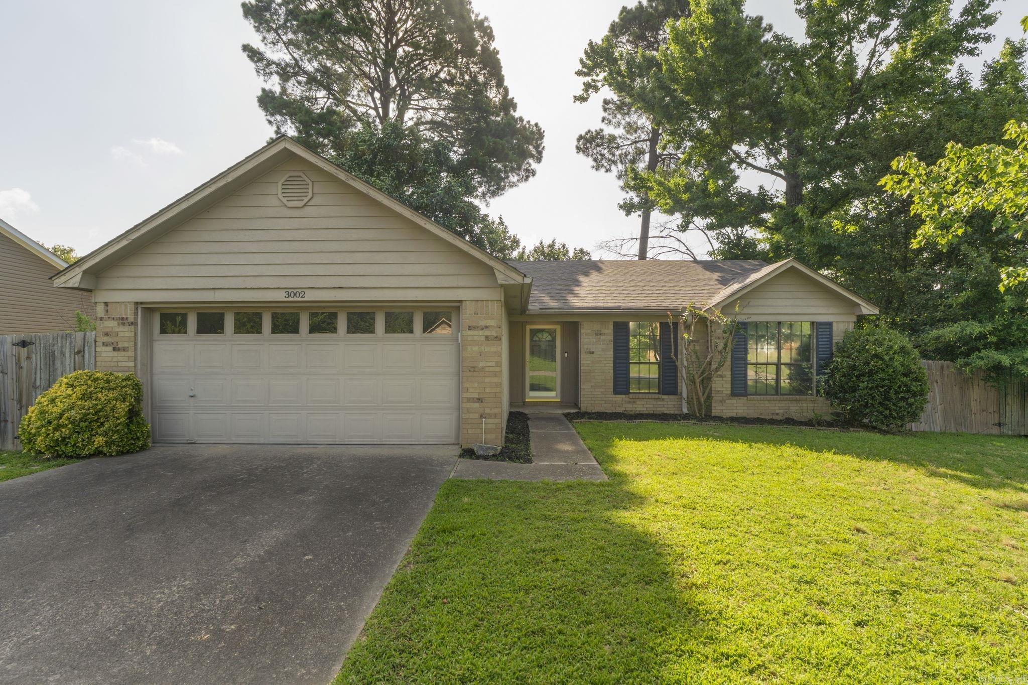 Welcome home to this beautifully updated 3-bedroom, 2-bath home in a prime location, just minutes from shopping, dining, parks, and everything you need—all within the highly sought-after Bryant School District. Fresh updates throughout create a move-in-ready space you'll love from day one. The inviting living room features a cozy fireplace, making it the perfect place to relax or gather with family and friends. The spacious primary suite offers a private en-suite bath and a walk-in closet for added comfort and convenience. Step outside to enjoy the fenced backyard, where a large deck sits under mature trees, creating a peaceful setting for entertaining, grilling, or simply unwinding. Combining modern updates, an ideal location, and a private outdoor retreat, this home is ready for its next owners. Don't miss your opportunity to make it yours! Buyers are encouraged to verify square footage, lot size and any other items important to them. No seller property disclosure. Some photos have been virtually staged.