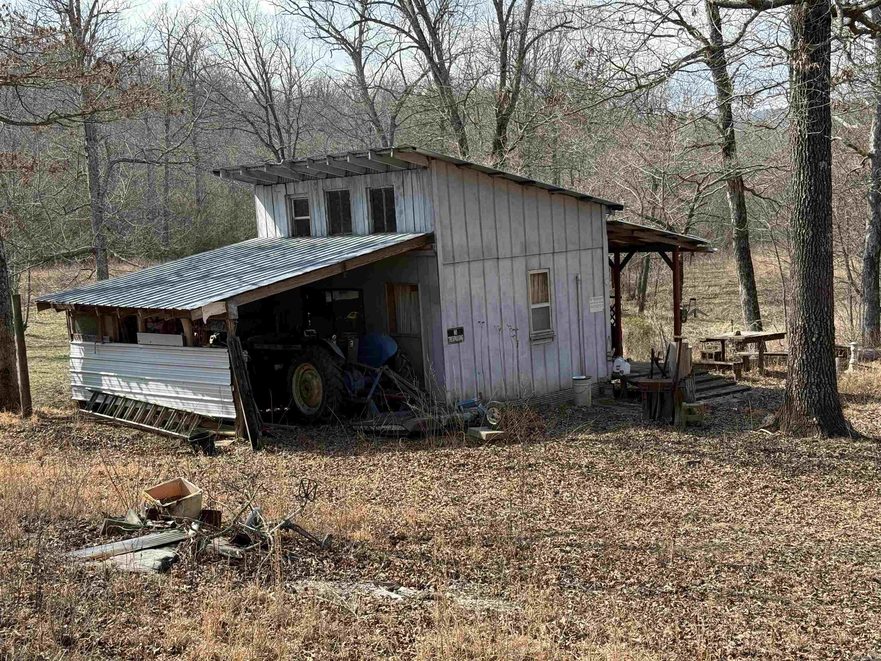 78± acres located just outside Leslie in Searcy County, AR featuring over 1/4 mile of Middle Fork Little Red River frontage along part of the north boundary. This property is set up and ready for hunting with multiple deer blinds, game feeders, established food plots, game ponds, and a well-maintained trail system throughout. The land offers classic Ozarks features including timber, cliffs, rock outcroppings, and natural springs that support abundant wildlife. A cabin with electric is in place, and high-speed fiber internet is available. Ideal for a hunting retreat, recreational getaway, or potential full-time rural residence. Rare opportunity to own river frontage with established improvements in North Central Arkansas. MLS 26007691 joins this property if additional acreage is needed.