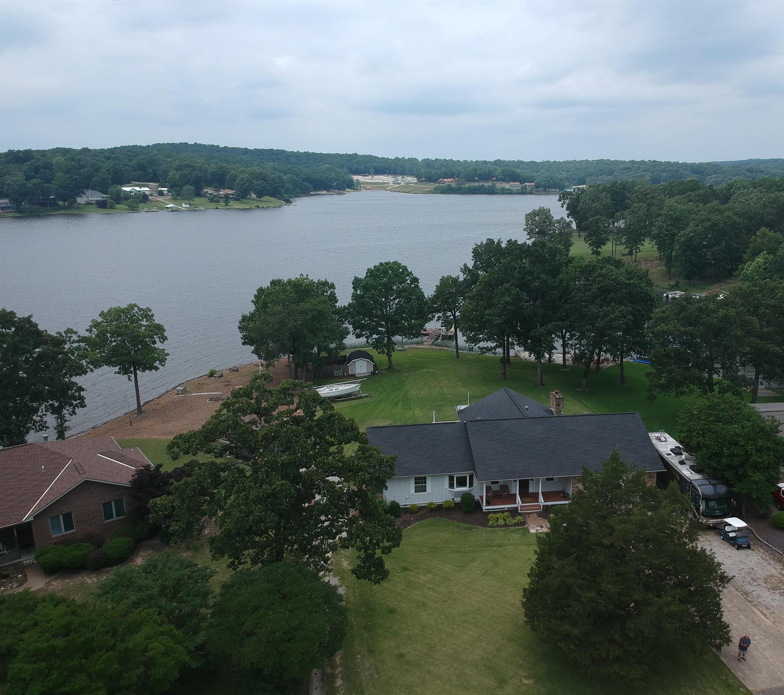 Stunning Lakefront Home on Beautiful Crown Lake - A Must-See! Don't miss this rare opportunity to own a beautifully updated lakefront home with panoramic breathtaking views of Crown Lake!  This spacious 3-bedroom, 2.5-bath residence offers the perfect blend of modern comfort and serene lakeside living. Step inside to discover a thoughtfully updated interior featuring: New luxury vinyl flooring throughout Maple cabinets Corian countertops in the kitchen.  Gas stove, refrigerator, and convection microwave included.  Anderson windows and a new roof (2021) fo] Gas log fireplace to warm up cozy evenings Zoned heating and cooling (4 zones via heat pump) for personalized comfort Spacious master suite with walk in closet Two large pantries and ample storage throughout.  Dual hot water heaters. The gentle sloping backyard leads to your private boat dock.  Outdoor features include: Deck perfect for relaxing or entertaining. Concrete paver patio with firepit ideal for grilling and gathering. Two-car garage with additional parking and two camper/EV 50 Amp electrical pedestals.  Sprinkler system and outdoor storage shed. Come see it today.