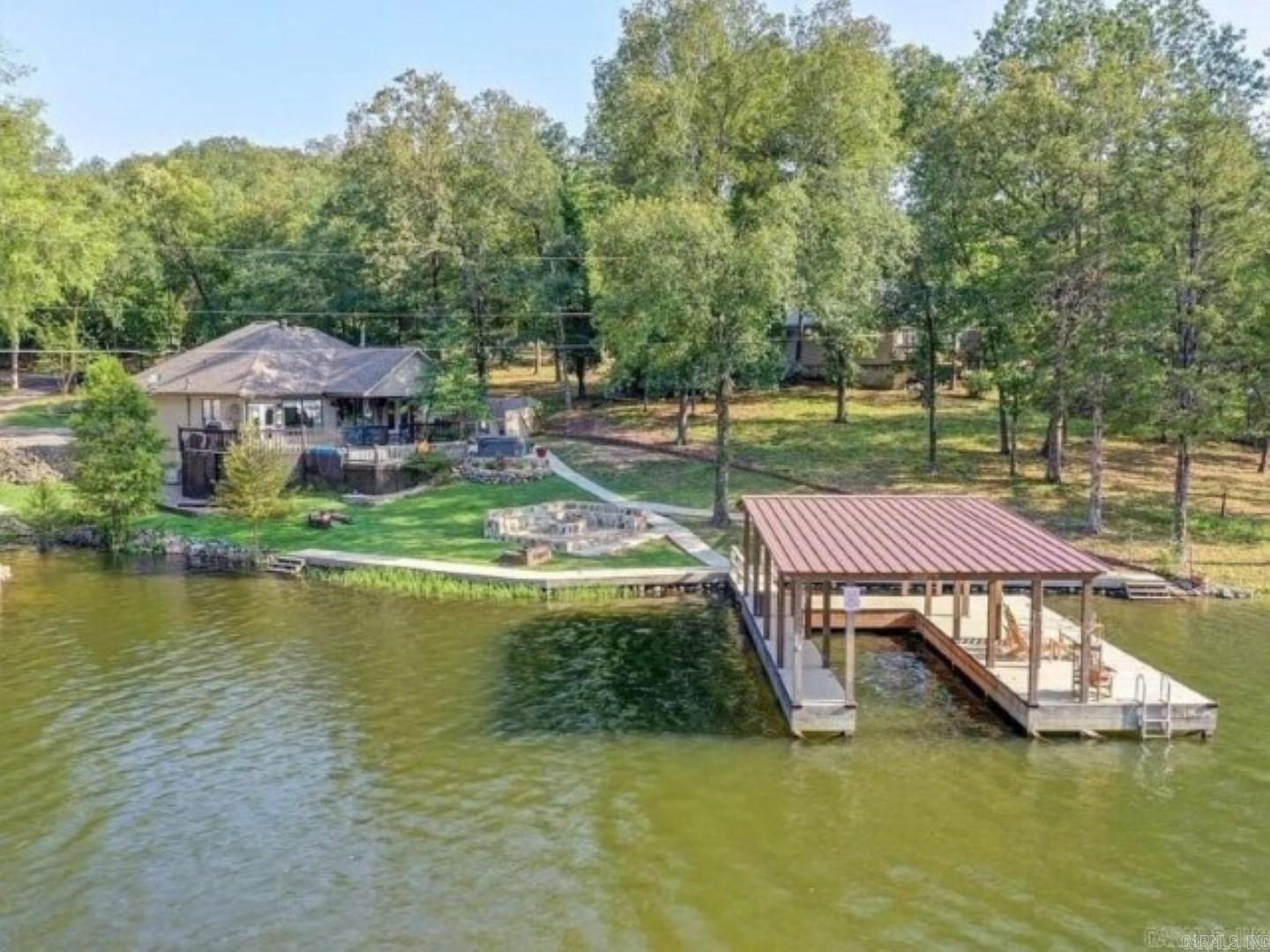 FULLY FURNISHED 1,968+/- SF 3 Bedroom, 2 Bath Home on Lake Hamilton !! Beautiful waterfront luxury home, half-acre and 172' of waterfrontage. The main home is 3 bed, 2 bath with modern style and updated, open floor plan. Covered boat dock, AG pool, hot tub. GUEST COTTAGE is a Huge Addition offering a Cozy 532+/- SF and is a perfect small vacation rental. Small loft bedroom area, Sofa with pull out bed, full bath and full kitchen open floor plan. Contact Fowler Auctioneers for more information.     Visit www.fowlerauctioneers.com for further details.