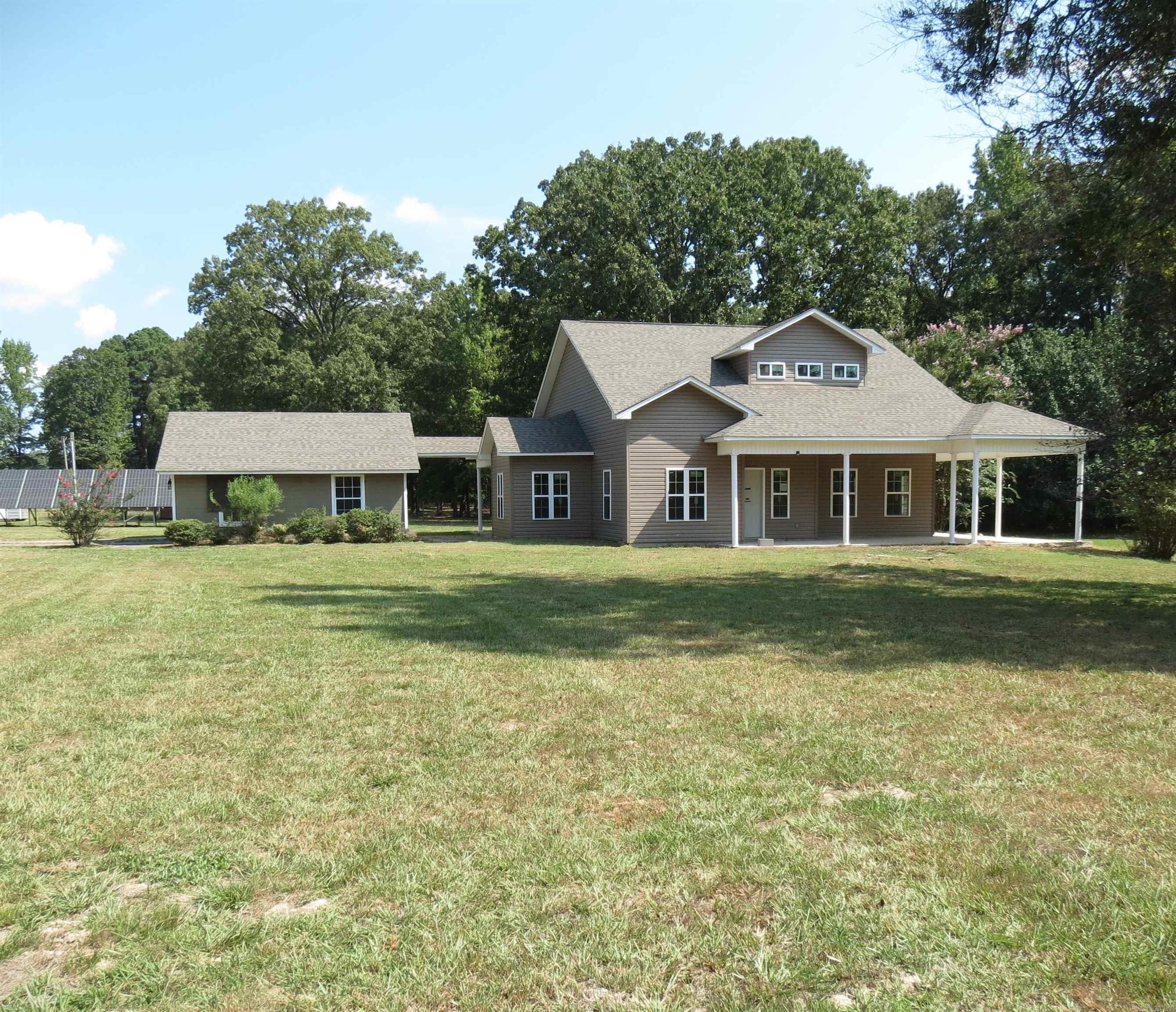 Wow this is a unique home!!!  Located outside city limits on 4.064 acres.  The original home burned and a new home was built on the slab.   This is like moving into a brand new home! Discover the perfect blend of comfort and tranquility in the spacious two-story home in the rural setting. With 4 generously sized bedrooms, including a primary suite with ensuite bath.  Lots of windows that flood the space with natural light.  Detached garage.  Taxes do not reflect the new home.  Square footage is based off existing slab.  Call today to own a slice of rural property. **Agents See Remarks**