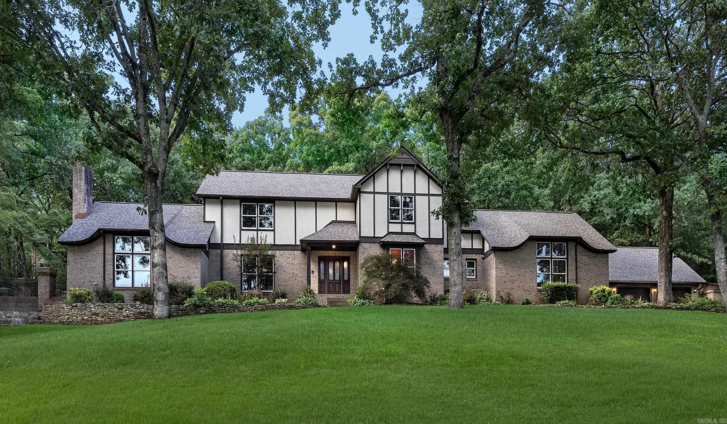 Tucked beneath a canopy of mature trees in Pleasant Valley's prestigious neighborhood, this distinguished 3,370-square-foot residence blends timeless architecture with exceptional comfort. Offering 4 bedrooms, 3 full baths, an attached 2-car garage, and a detached 3-car garage, the home provides remarkable flexibility for collectors, hobbies, or additional storage. The breathtaking vaulted great room serves as the centerpiece, showcasing soaring ceilings, rich wood paneling, exposed beams, custom built-ins, and a striking floor-to-ceiling fireplace. Expansive living spaces are filled with natural light, creating an inviting atmosphere for both elegant entertaining and everyday living. Surrounded by mature landscaping and exceptional privacy, this home offers a peaceful retreat just moments from Pleasant Valley Country Club, premier shopping, dining, and top conveniences.