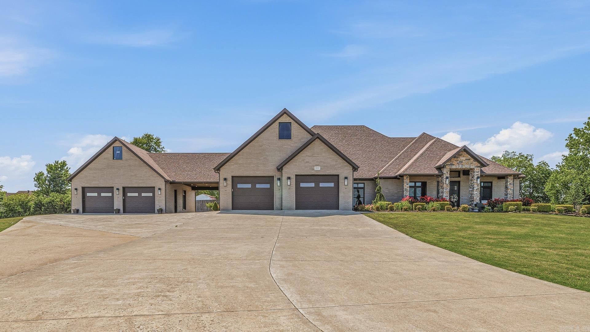 Custom luxury home with modern touches on 4.47 acres of land, Welcome to this stunning custom built residence at 4208 West Kingshighway in Paragould offering over 3400 square feet of thoughtfully designed living space on a beautifully landscaped, tree lined land. This all brick home features a desirable split bedroom floor plan with three spacious bedrooms, each offering private ensuite baths and generous walk in closets for comfort and privacy. The inviting foyer opens into an elegant formal dining room and an expansive great room designed for entertaining and everyday living. A bright sunroom and relaxing screened porch overlook the lush outdoor setting and create additional spaces to unwind year round. The custom details and upgrades throughout reflect quality craftsmanship and timeless style. A safe room adds peace of mind while the attached shop offers exceptional versatility for hobbies, storage, or workspace needs. The porte cochere and charming breezeway beautifully connect the home and shop while adding character and functionality to the property. Rarely does a property combine this level of custom design, space, and setting all within the city limits.