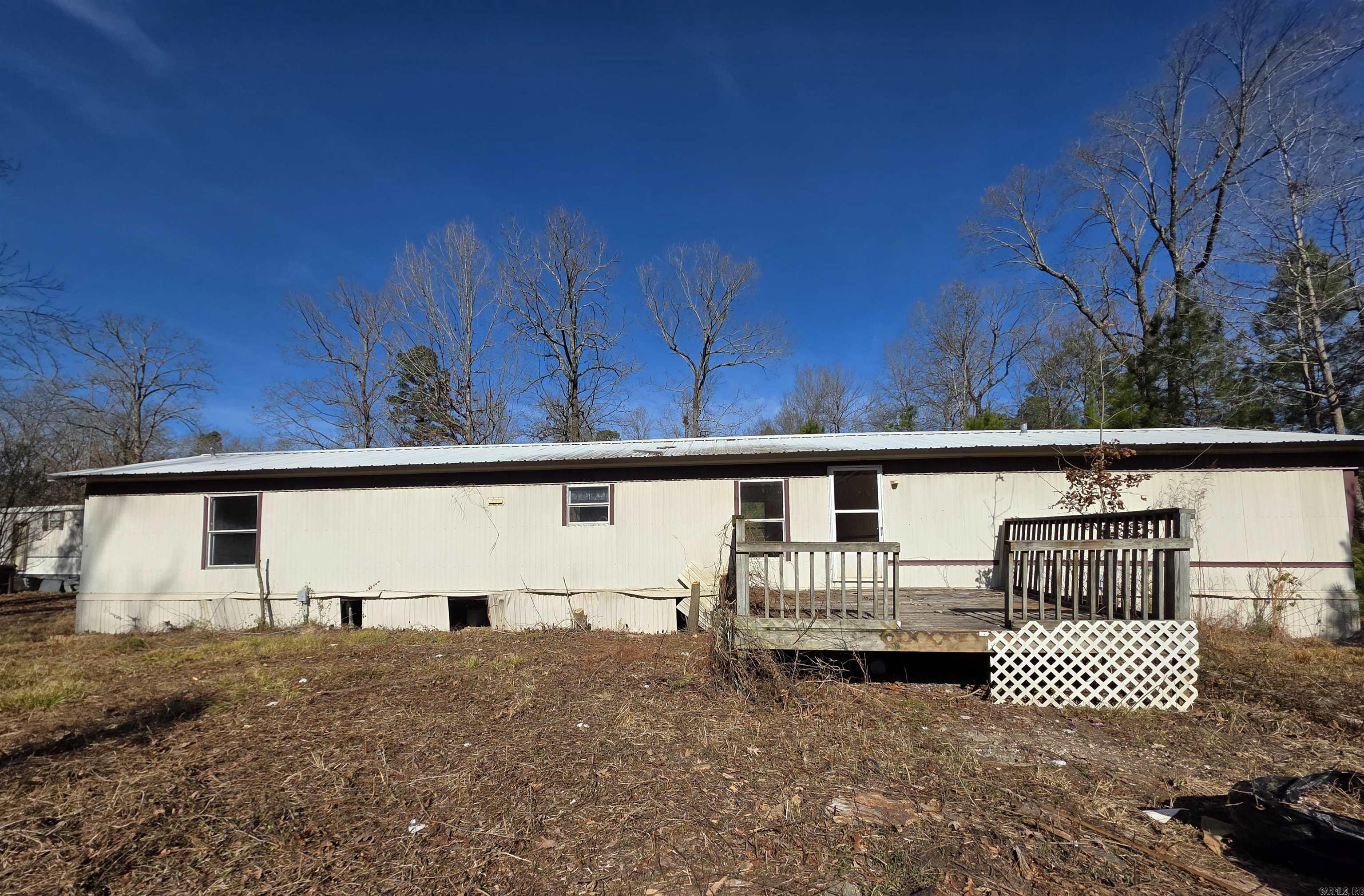 Great opportunity to own a mobile home situated on 2 spacious acres just outside city limits. This property offers plenty of room to spread out, enjoy privacy, and create your own rural retreat.  The mobile home needs some work, making it ideal for investors, handy buyers, or anyone looking to customize a home to their taste. The land provides ample space for gardening, animals, outdoor projects, or future improvements.  Enjoy the benefits of no city restrictions, lower taxes, and peaceful country living while still being within reasonable distance to town amenities.  Property is being sold as-is. Bring your vision and turn this property into something special.