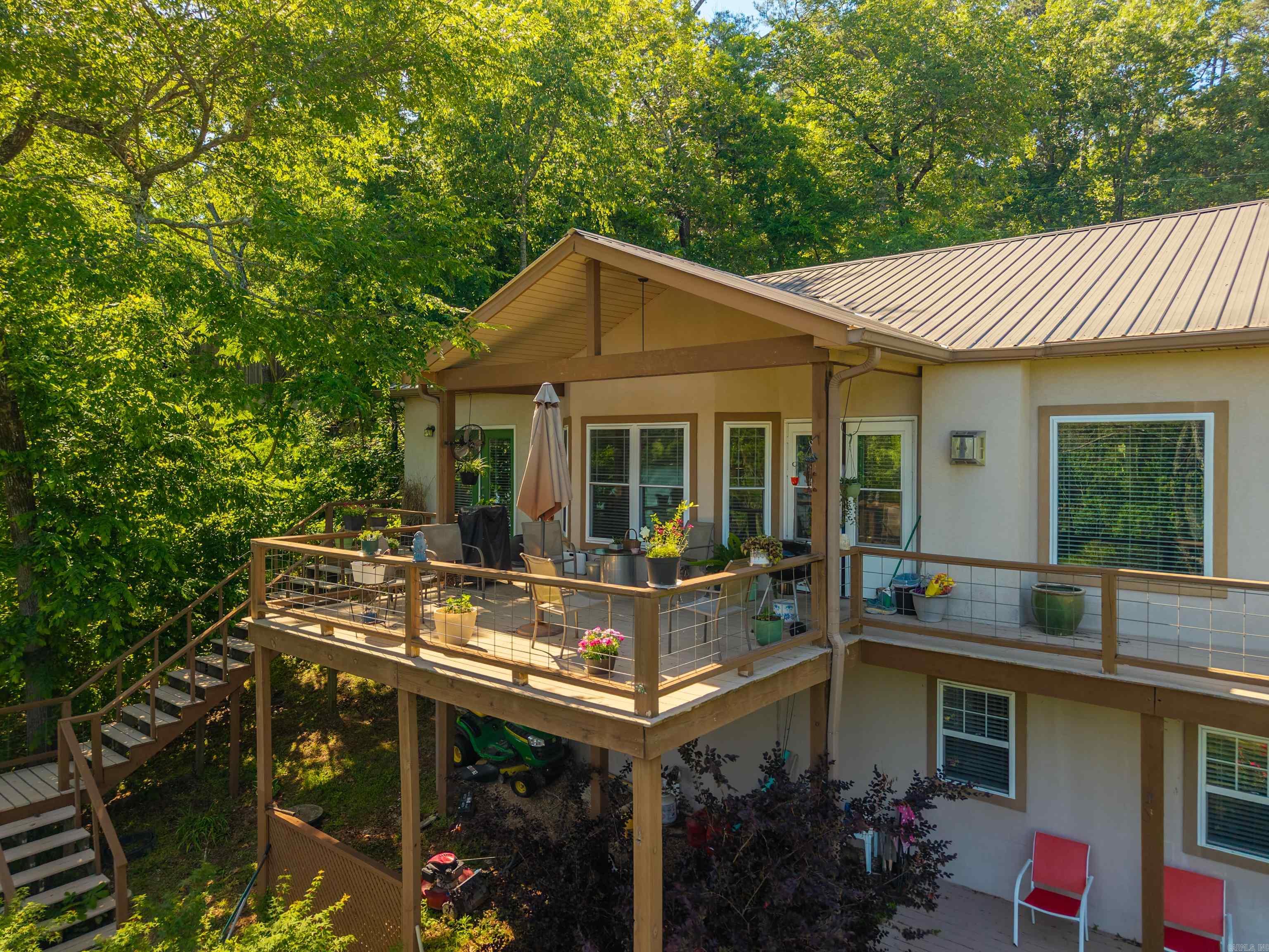 This lake house has it all, welcome to 415 Kirschwwod Drive! Spacious 3 bedroom, 3 bath home featuring a versatile bonus room downstairs, perfect for a game room, office, or guest space. 2 car garage with a brand new driveway, separate laundry room, large walk in closet and tons of storage space downstairs! Nestled in a year-round deep-water cove with a private boat dock, 140ft of water frontage, this property offers easy access and exceptional waterfront living. The covered back deck offers views of the main channel and perfect for entertaining! Located right down the street from Treasure Isle boat ramp and out of city limits, this could be a lucrative short term rental!