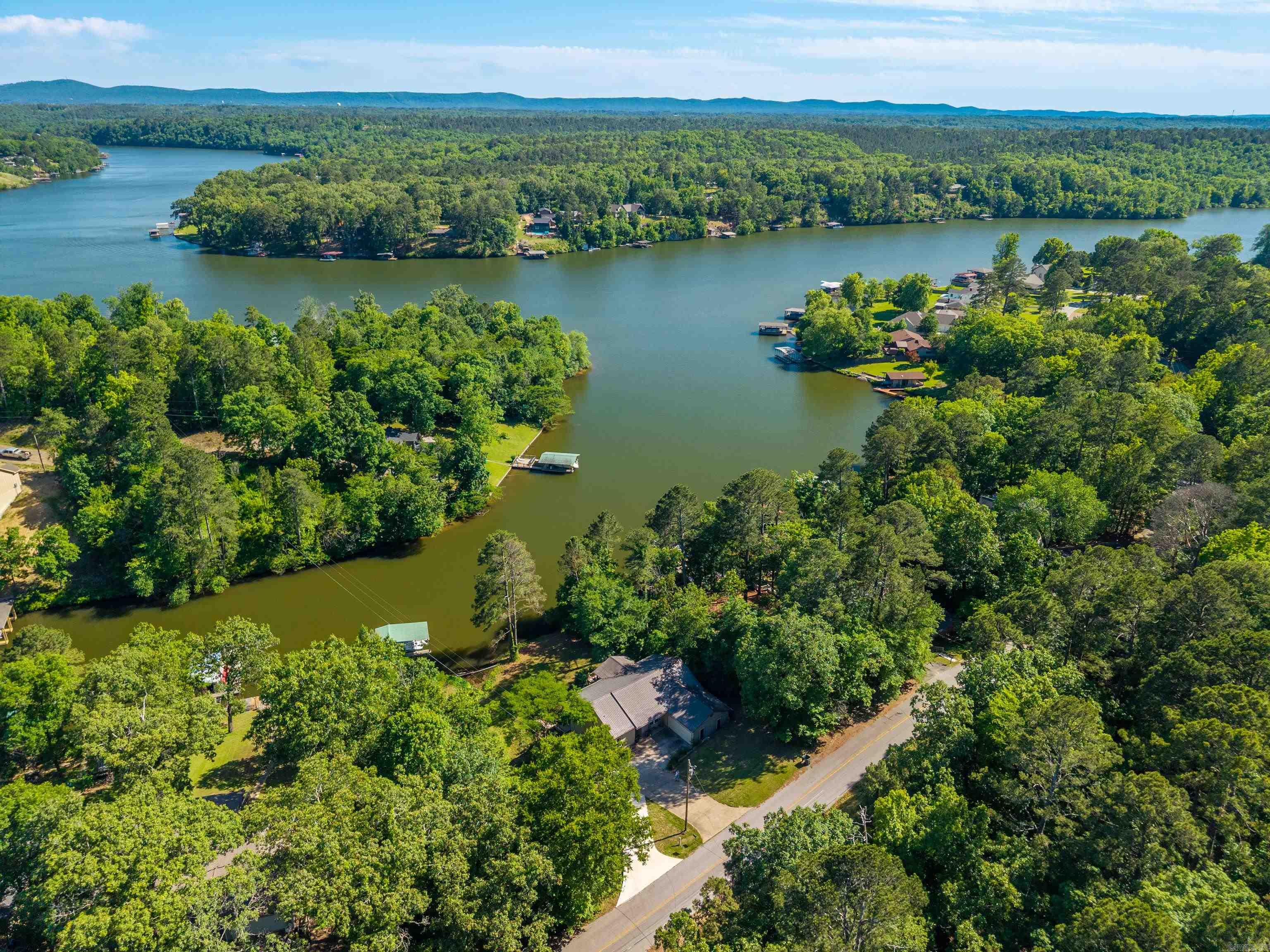 This lake house has it all, welcome to 415 Kirschwwod Drive! Spacious 3 bedroom, 3 bath home featuring a versatile bonus room downstairs, perfect for a game room, office, or guest space. 2 car garage with a brand new driveway, separate laundry room, large walk in closet and tons of storage space downstairs! Nestled in a year-round deep-water cove with a private boat dock, 140ft of water frontage, this property offers easy access and exceptional waterfront living. The covered back deck offers views of the main channel and perfect for entertaining! Located right down the street from Treasure Isle boat ramp and out of city limits, this could be a lucrative short term rental!