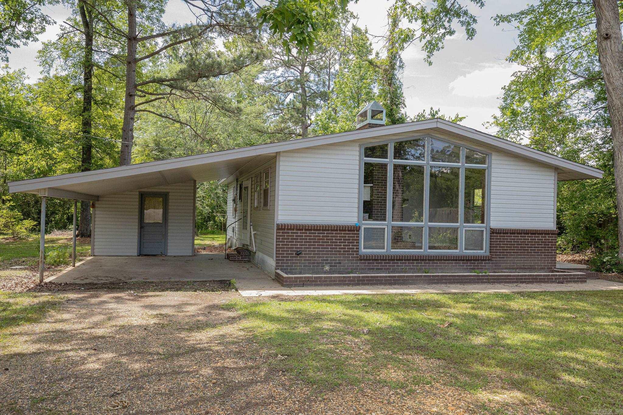 Charming and full of character, this cozy 3 bedroom 1 bathroom cottage was beautifully remodeled in 2021. The living room features tall ceilings, nearly floor to ceiling windows, and a wood burning stove. The kitchen has new cabinets, butcher block countertops, and a gas range. All the big things have been updated recently such as new roof 2024, a/c unit 2018, and hot water heater in 2021 providing peace of mind for years to come. This home seamlessly blends modern updates with timeless charm. Schedule your showing today!