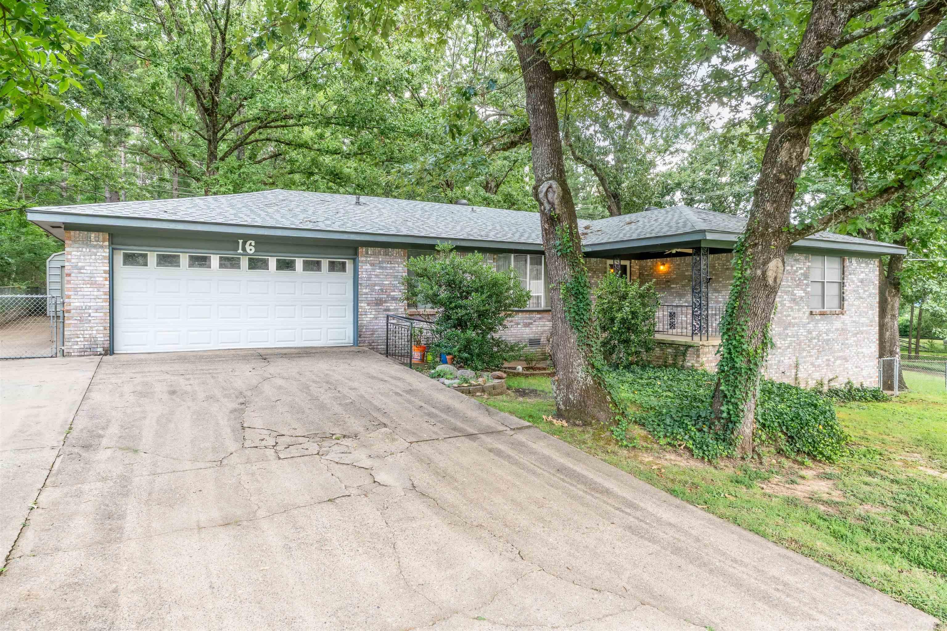 Spacious, 2BR/2.5BA, well-maintained brick home with a 2-car garage and extra side parking, ideal for multiple vehicles or guests! This property features not one, but two shops—both with electricity—including a large detached shop with dual bay doors, perfect for anyone needing space to work on cars, equipment, or hobbies. Sitting on nearly half an acre, the home also includes an additional lot in the backyard, providing added privacy, mature shade trees, and room to expand. There's an extra flex room that could easily serve as a 3rd bedroom. You will not believe all the storage space you will find here! One of the full bathrooms is handicap accessible.  The kitchen includes the refrigerator, and the washer and dryer convey as well. There’s also ample walk-in storage underneath the house and floored attic space. This is a rare find for buyers needing space to work, store, or spread out, all while enjoying the comfort of a solid brick home in a peaceful setting that's close to LRAFB, schools and shopping! Agents See Remarks.