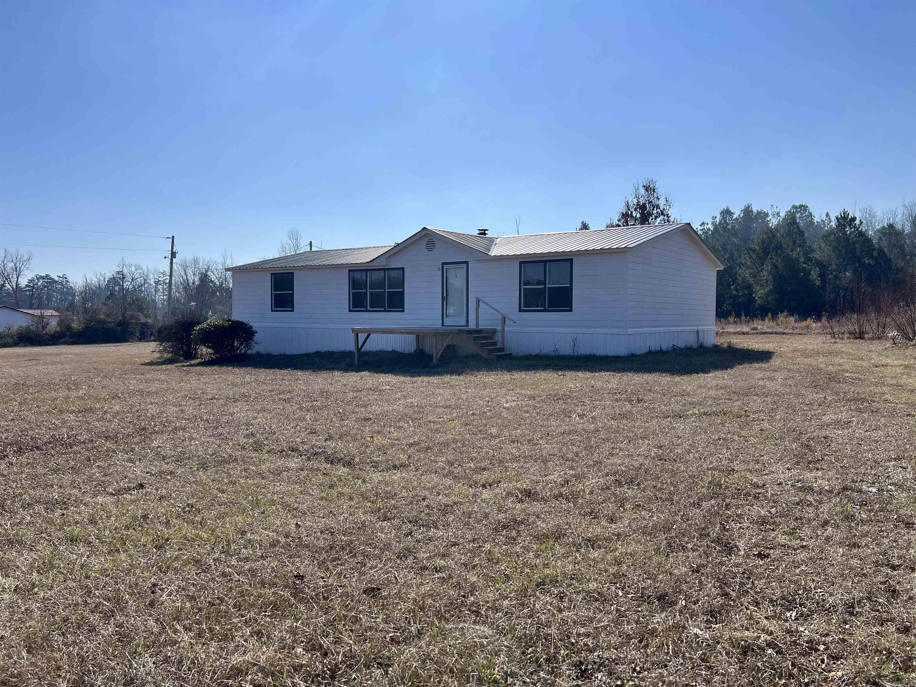 Newly remodeled 3 bed 2 bath home on 3 acres in a great location! This 1568 sq ft mobile home has New roof, Siding, floors, paint and hvac. It's ready for its new family. The kitchen has plenty of counter space and beautiful built in China cabinets. Each bedroom has walk in closets and spacious enough for all your furniture. The den has a decorative fireplace, perfect for seasonal decor, and is large enough for easy entertaining. The primary suite is separate from guest rooms and has a garden/soaker tub with a separate shower. This home has plenty of storage and is offered at a great price! pre-approval required for showing