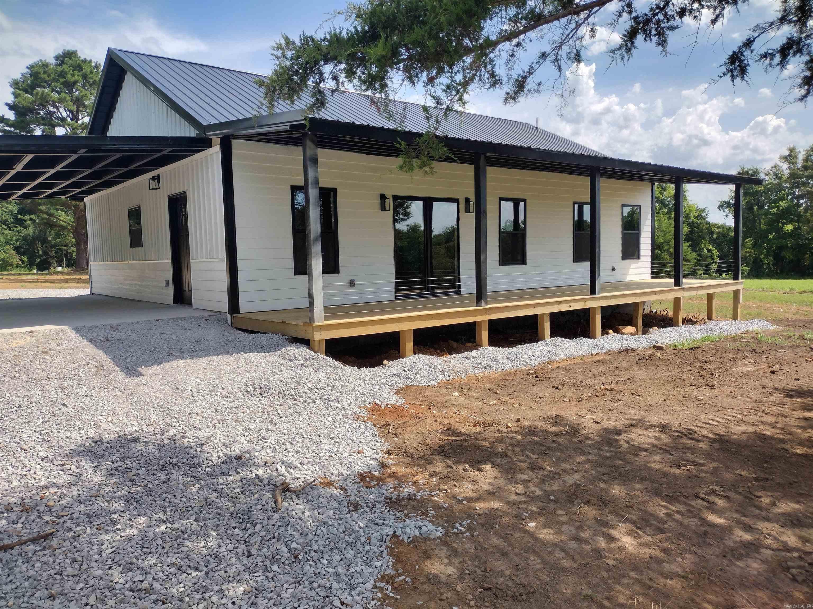 Beautiful new construction home situated on 3 acres m/l with scenic views from the front porch! This well-constructed home offers 3 bedrooms and 2 bathrooms with an open layout featuring concrete countertops and brand-new appliances. The property is on public water and includes a new state-approved septic system. Conveniently located approximately 15 minutes from town and just 10 minutes from Dollar General, with easy access to Blanchard Springs Caverns and the Ozark National Forest. Enjoy the perfect blend of peaceful country living and nearby amenities in this move-in-ready home! with one car carport also has two additional septic permits if you wanted to build mother-in-law quarters.