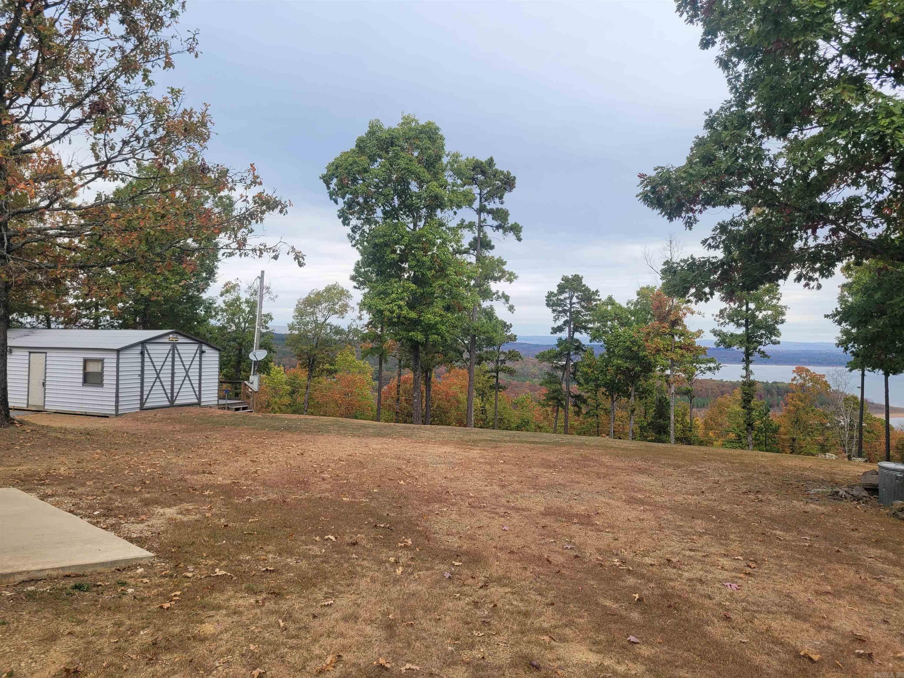 Here it is!!! What everyone is looking for! NO RESTRICTIONS with the breathtaking view of Greers Ferry Lake. All the hard work for the perfect building spot has already been done. Stay on site in the cozy cabin while you build your forever home. Not ready to build right away, then you have the perfect lake getaway ready and waiting. Storage building with concrete floor and electricity for boat and all the lake toys. Circle drive for the ease of pulling trailers in and out and also provides plenty of parking. This property is on a well. Agents, please see all remarks.