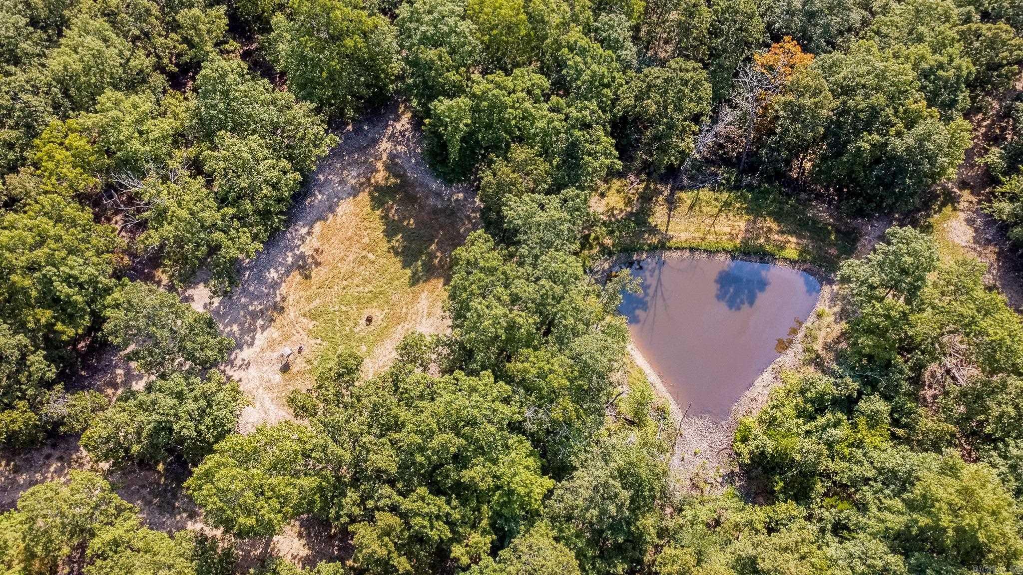Located in the heart of the Ozarks in Ravenden, Arkansas, this exceptional 290 +/- acre property spans both Randolph and Sharp counties and offers a true turn-key experience for outdoor enthusiasts. The land has been meticulously maintained and thoughtfully developed, featuring over 5 miles of well-kept internal roads, multiple food plots, two natural springs, and two ponds. Wildlife is abundant, with a thriving population of deer, turkey, and the occasional bear. Hunting infrastructure is already in place with four enclosed box stands, eleven ladder stands, and twelve feeders strategically positioned across the property.  The property includes a fully furnished 2017 16'x80' mobile home, a 20'x40' shop for equipment storage, and a deer cooler - perfect for weekend getaways or full-time living. Also included is a 2022 John Deere 5090E tractor with a 5-foot Remlinger no-till drill and several other implements, making land management easy and efficient. With high-speed fiber internet already installed and located just 50 miles from Jonesboro, this property offers the perfect blend of seclusion, comfort, and accessibility.