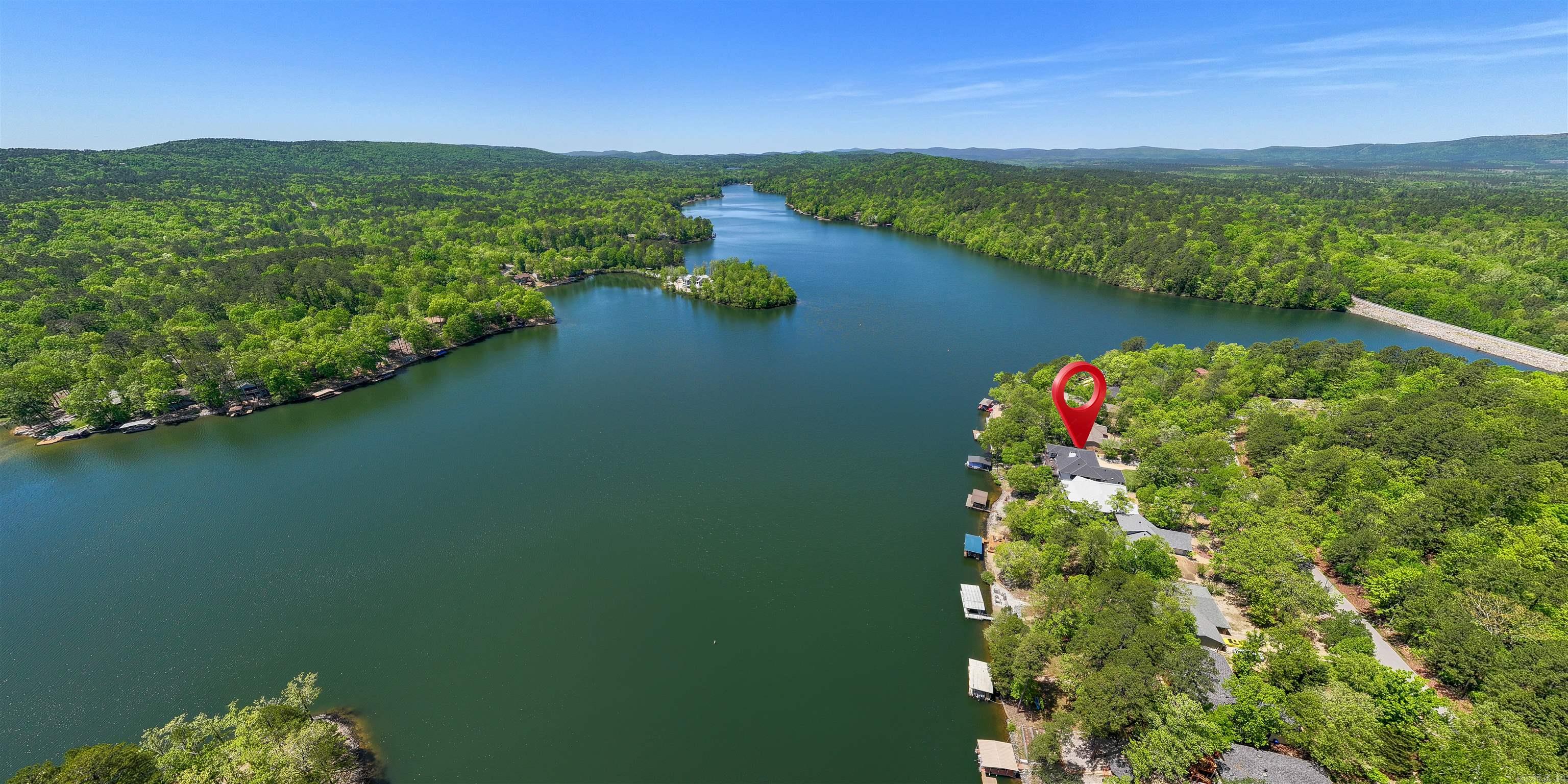 WOW! What a GORGEOUS Remodel! Top to bottom, this Premium Lake Cortez Waterfront Home has been Elegantly Renovated to reflect its true potential! With 4 Bedrooms + Den + Bonus, 3 Fireplaces and a HUGE Storage Room with Utility Sink and added Closets, this home has room for everything, including multi-generational living or income potential As you enter, Pristine Lake Views greet you from floor to Vaulted Ceiling Windows! Be Wow'd by Lake Views from nearly every room, including the newly designed Great Room with Wet Bar.  The adjacent Kitchen has all New, Stainless Appliances (including 3 Ovens + Convection Oven/Microwave), Custom Cabinetry, Elegant Glass Backsplash, and beautiful Quartzite Countertops. Choose to dine from your Lake View Center Island (with ample storage), Kitchen Nook with Crystal Chandelier, entertainment-sized Formal Dining Room or your Huge Outdoor Deck.  The expansive Lake Views continue into your Spacious Primary Bedroom with a Spa-like Ensuite and Walk-in Closet! The Lower Level features a Lake View Living Area, 2 Bedrooms and a Flex Room. Walk-out to the Patio and Fully Fenced Yard to enjoy Lake Living from your Covered Boat Dock! Aprox. 70' Waterfront!