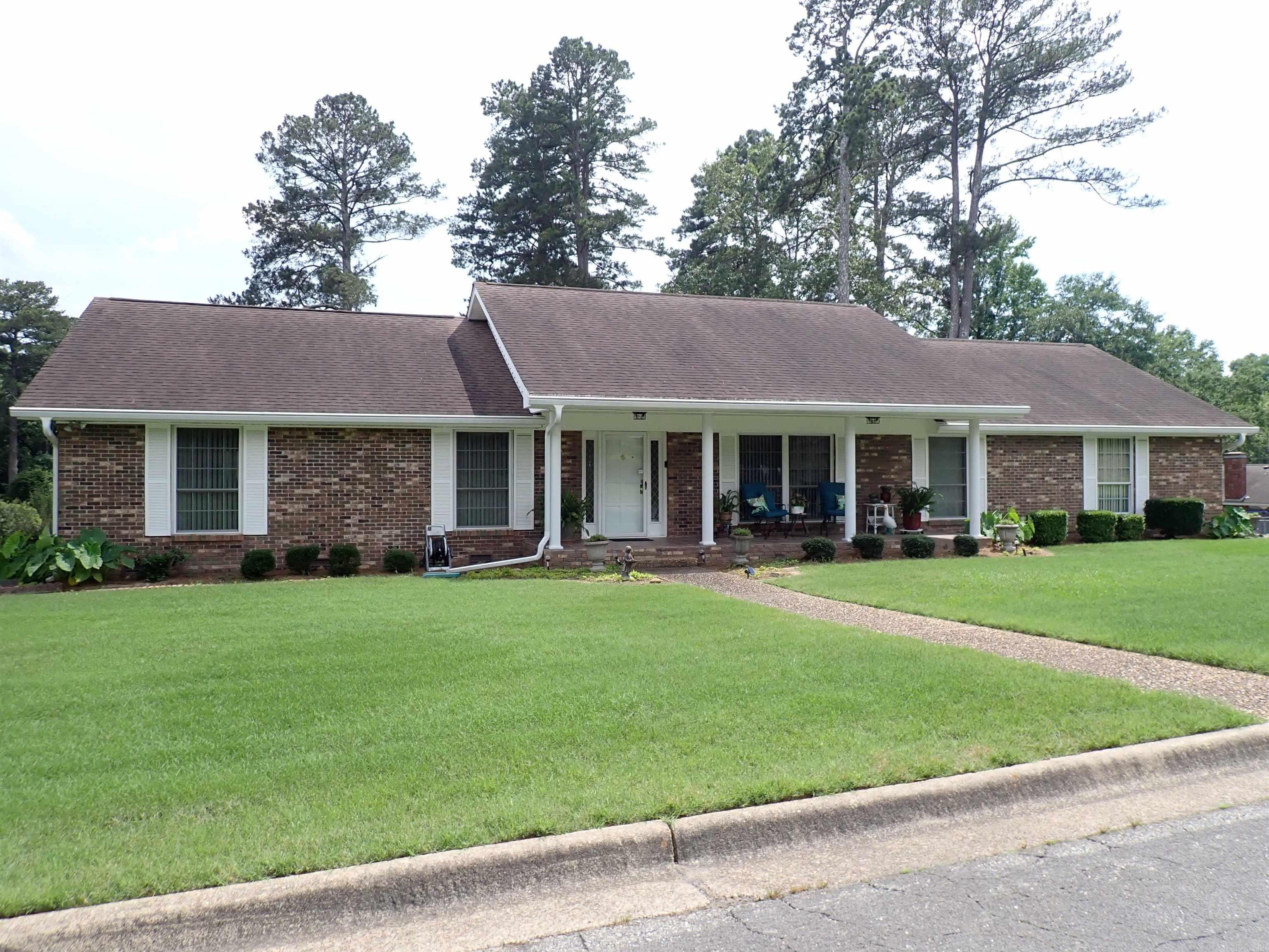 Awesome, TRADITIONAL, Brick Residence --- All on ONE LEVEL!  Wide 'covered' FRONT PORCH with columns & a porcelain tile floor, an ENTRY HALL, separate LIVING ROOM, Formal DINING ROOM, a big FAMILY ROOM with brick FIREPLACE and display cabinetry, an UPDATED 'eat-in' KITCHEN with NEWER CABINETRY and pretty STAINLESS APPLIANCES, a LAUNDRY area & half-bath.  Hallway to BR's features an extra clothes closet, a recently REMODELED HALL BATHROOM (full) with linen/storage closet, 3 NICE-SIZED BEDROOMS --- all with clothes closets, and a private PRIMARY BATHROOM with walk-in shower.  Double garage & a fabulous, REAR DECK/SCREENED PORCH (12' x 16') NEW in 2023 with metal roof & a wonderful 'JETTED' HOT TUB (New 2024)!  Also, NEWER PRIVACY FENCING (2024) & a detached STORAGE Building located off the driveway area!  This home's CH/A was replaced in 2020 (Frigidaire) & the Architectural Shingles were  replaced in 2018.  Gutters were added on the rear roofline (above the backyard area) in 2025.  And, believe it or not, the lawn was NEWLY SODDED in 2024:  Bermuda sod in the front yard -and- St. Augustine in the back yard.  UNBELIEVABLE!  This all sounds TOO GOOD TO BE TRUE, but it's FOR REAL!