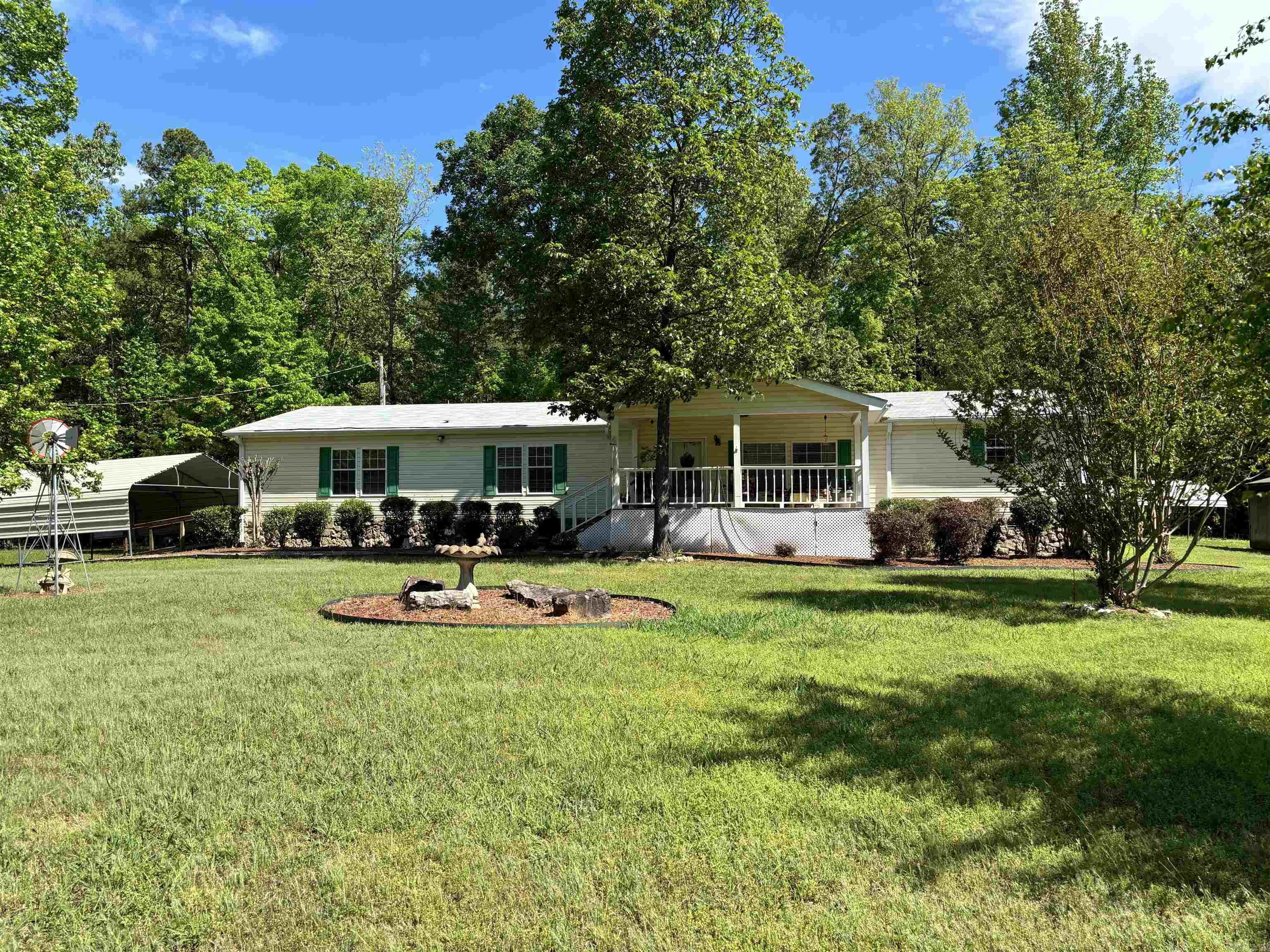 Wonderful Location..(with acreage) mostly level-3.45 acres.. Country but easy access to shopping and Interstate; ..Come on home ..sit on the front porch... Huge greatroom; ...Lge Sep dining room; Kitchen w/island and Breakfast bar;  Lge Master Suite... w/ Sep whirlpool and Shower plus sitting room/office/or sewing room... 3 other generous size bedrooms w 2 additional bedrooms; Lge Laundry room - Deck out back; (plus handicap ramp at backdoor) detached metal 2 car carport stg Bldg   +storm celler   note: single carport behind home does not remain