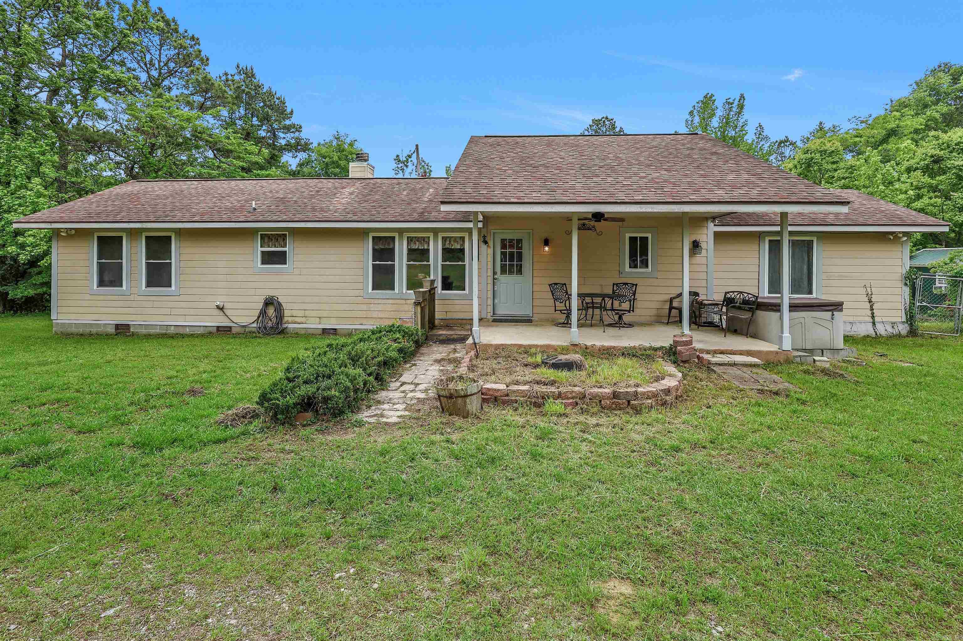 Surround yourself with the natural beauty of the Caddo Gap area at 549 Oak Grove Rd. Built in 2013, this 3-bedroom, 2-bath home offers approximately 1,344 square feet of comfortable living space on 2± acres.  Inside, you’ll find real wood flooring complemented by slate and carpet, along with a wood-burning fireplace that adds warmth and character to the main living area. A 15x7 sunroom provides additional flexible space—perfect for relaxing, hobbies, or enjoying views of the surrounding property.  The exterior features Hardiboard siding and a variety of functional improvements, including multiple storage buildings—three with electricity already in place (12x20, 12x32, and 8x12), plus an additional 16x10 building. For those needing space for larger equipment or travel accommodations, the property also includes 20x40 and 20x20 covered parking areas suitable for RV storage, complete with 50-amp service.  Serviced by both city water and a private well, the property offers added versatility. Located approximately 1 mile from the Caddo River, you’ll have convenient access to one of the area’s most popular outdoor destinations.