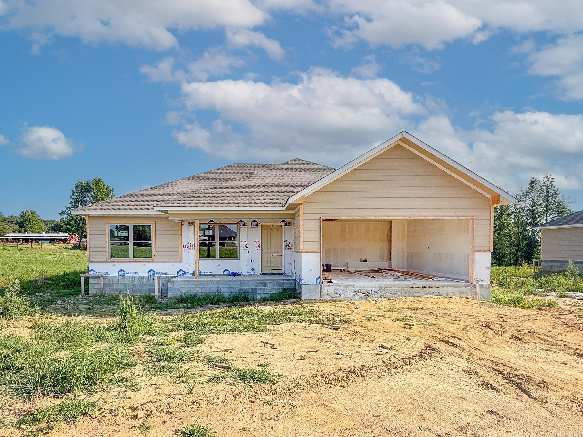 Beautiful new construction home situated on a spacious 1-acre lot! This open-concept design features stunning brick, rock, and Hardie board exterior finishes, a spacious kitchen with farmhouse sink and abundant cabinet storage, and a stylish accent wall that adds character throughout. The private primary suite offers a luxurious soaker tub and separate walk-in shower. Enjoy tile flooring in all bathrooms, a two-car garage, and a covered back patio with a gorgeous wood ceiling—perfect for relaxing or entertaining. Country living with modern finishes and thoughtful design!