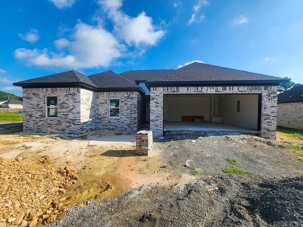 Located in the desirable Wellswood subdivision within the Greenbrier city limits and the Greenbrier School District.  This new construction home offers the perfect blend of convenience and comfort. With 4 bedrooms, 2 bathrooms, and 1,755 square feet, the open floor plan is designed for modern living and effortless entertaining. The spacious living area features an electric fireplace and flows seamlessly into the kitchen, complete with granite countertops, painted cabinetry, LVP flooring throughout, and an island with breakfast bar. A freestanding range and built-in microwave complete this functional and stylish space.  The private primary suite includes double vanities, a relaxing soaker tub, custom tile shower, and a walk-in closet. Three additional bedrooms provide flexibility for family, guests, or a home office.  Enjoy the outdoors from the large covered back patio that faces north so it's almost always in the shade! The brick exterior, two-car garage, and 1-year builder warranty add to the home's appeal and peace of mind.
