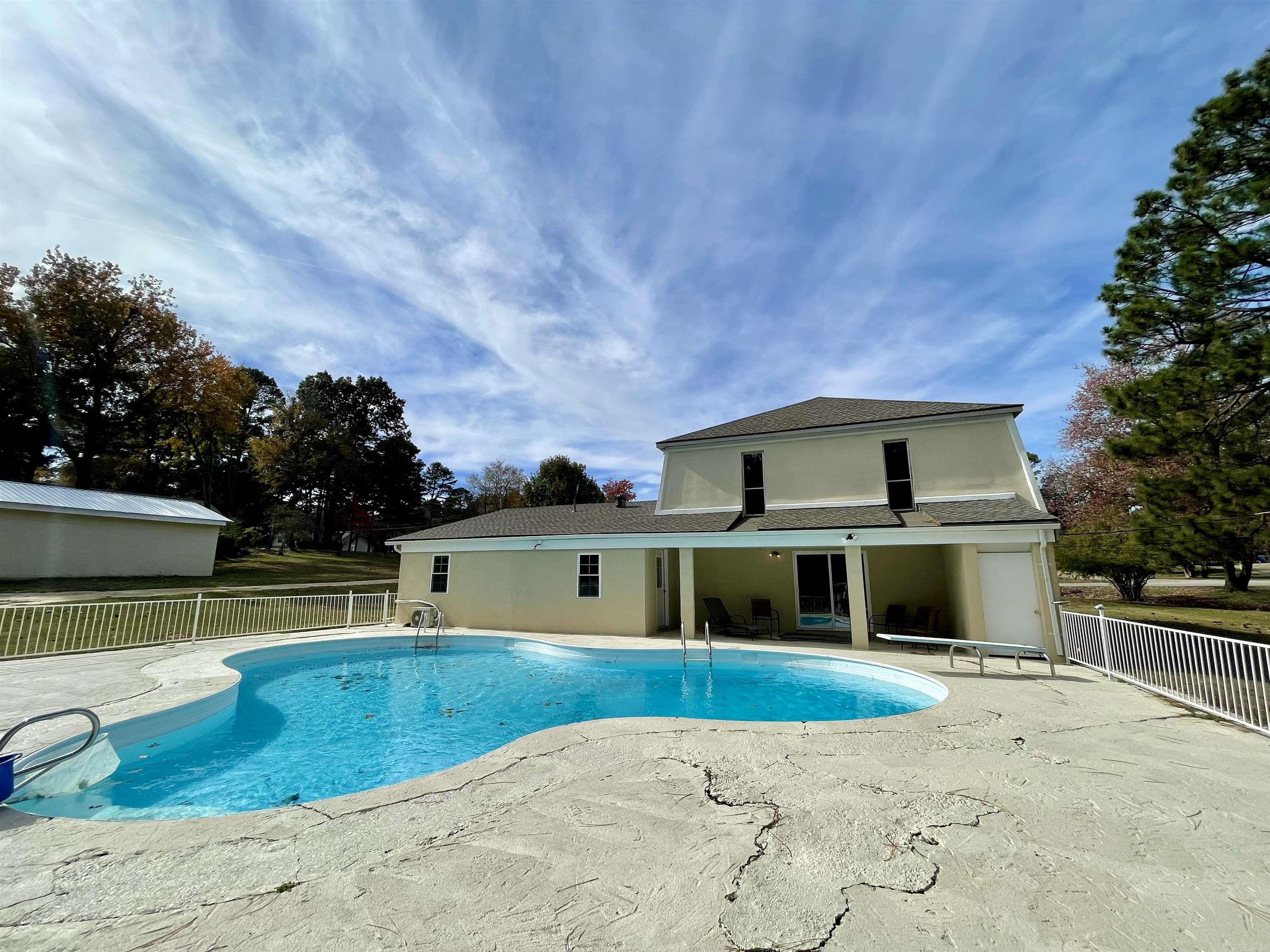 Tons of space, Acre lot, beautiful in-ground pool and 2 workshops! This home has been recently remodeled and has a new kitchen, new appliances, flooring, paint and more. There are 2 bedrooms on the main floor and up to 4 more bedrooms upstairs, or you could use it as a 4 bedroom with an office and 2nd living area. The pool has a metal fence surround. This home is located in Valley View School District. There is a driveway to the smaller shop, and it could be turned into a nice detached garage. The larger shop is built with metal studs.