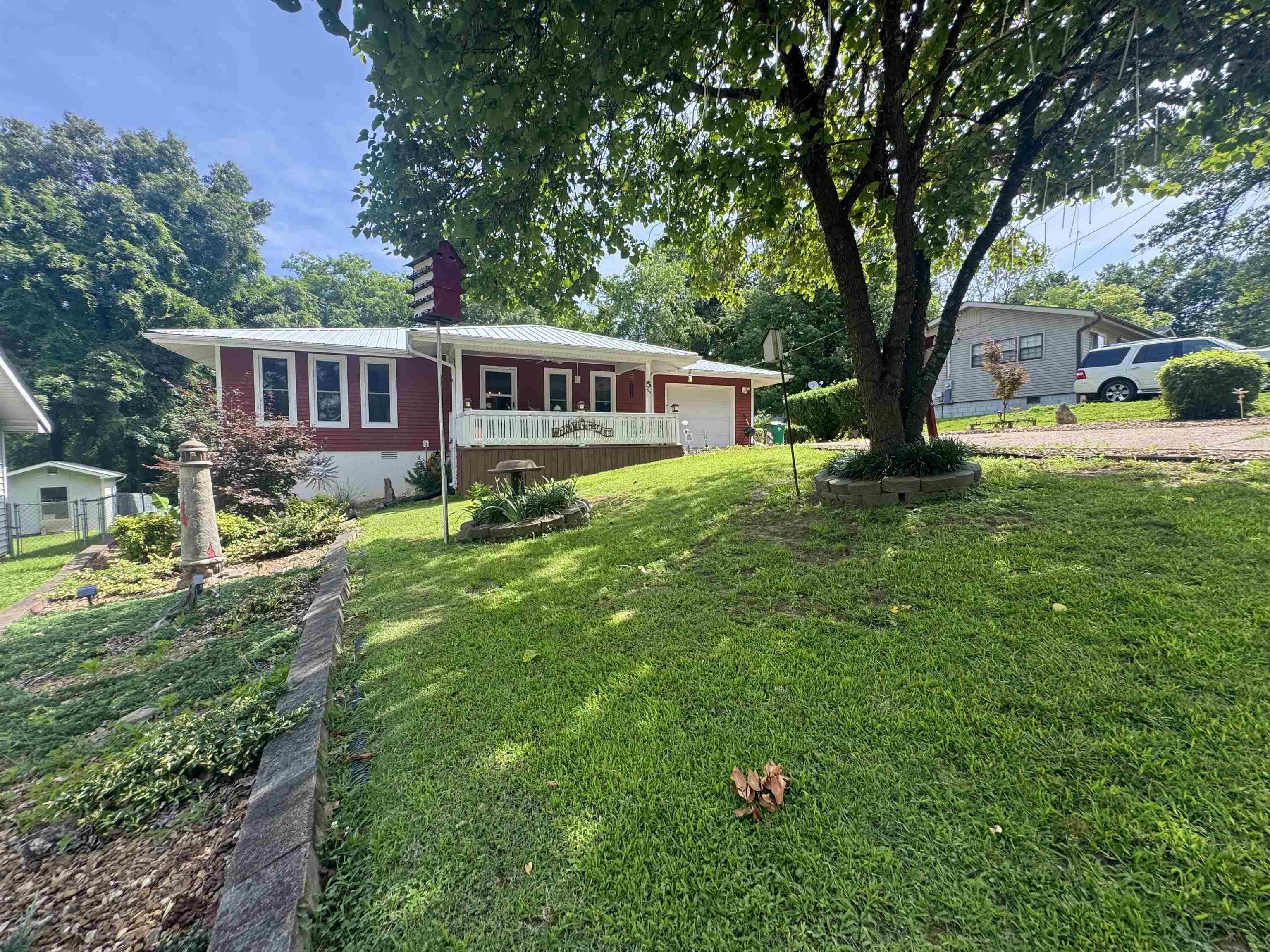 Beautifully maintained and immaculate, this Cherokee Village property offers a rare combination of space, setting, and location. Situated on 3 lots in a peaceful, parklike setting, this home is directly across from the Lake Sequoyah marina and Dogwood Park, making it easy to enjoy lake life, outdoor recreation, and the natural beauty of the area. The property also features a detached heated and cooled shop with 2 bays, providing excellent space for vehicles, hobbies, storage, or projects. Whether you are looking for a full-time residence, lake-area getaway, or a well-kept property with room to spread out, 5 Dogwood Circle is a must-see in the heart of Cherokee Village.