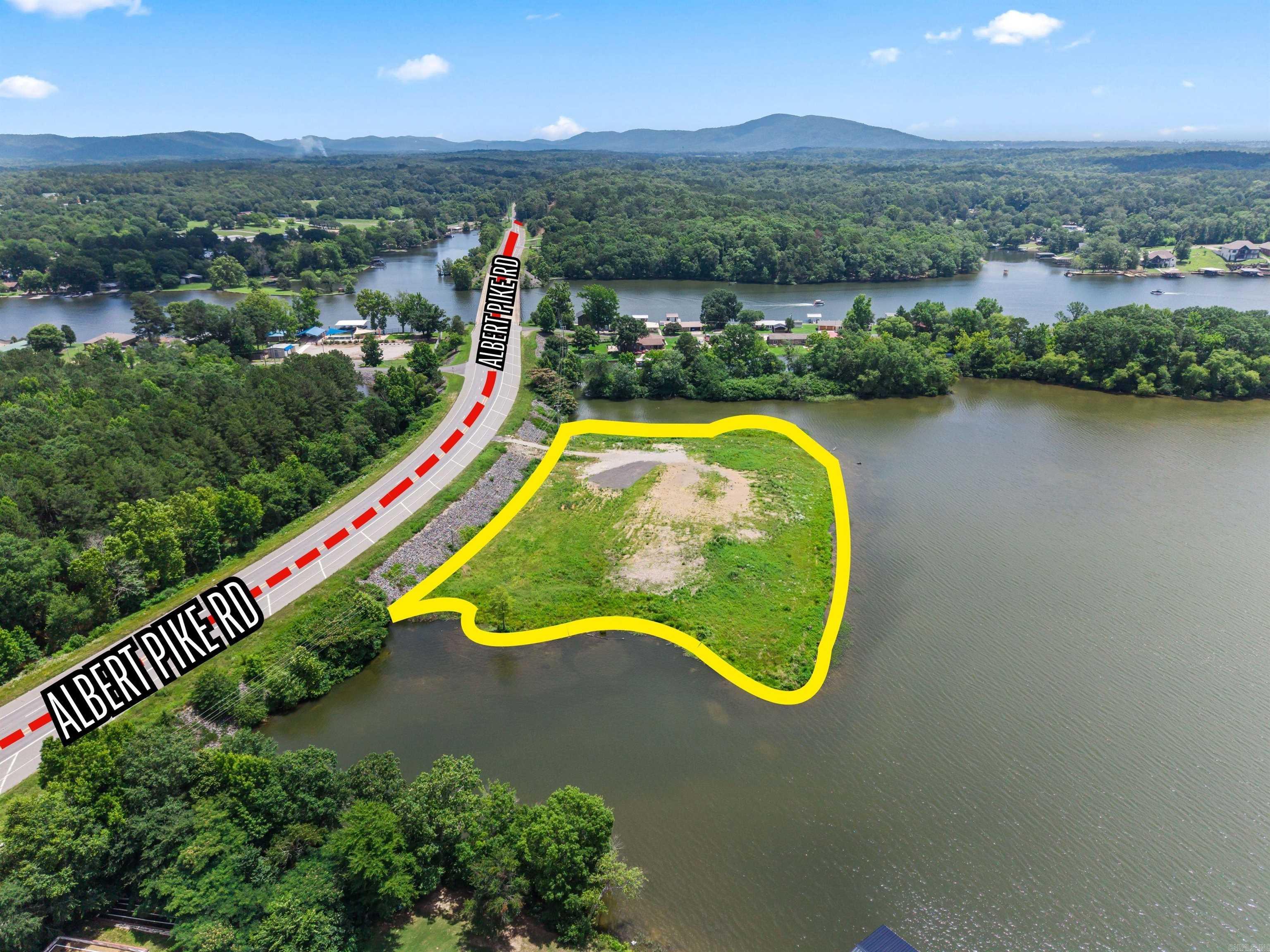 Ripe and ready for development- Prime Lake Hamilton Peninsula!! An exceptional opportunity to own 2.53 acres on a private peninsula along the shores of Lake Hamilton.  This unique waterfront property boasts approximately 1,000' feet of shoreline and 388' feet of frontage on Albert Pike (Highway 270 West), conveniently located just outside the city limits. With its expansive water frontage, excellent visibility, and easy access, this property is ideally suited for a luxury private estate, waterfront residential development, or other investment opportunities.