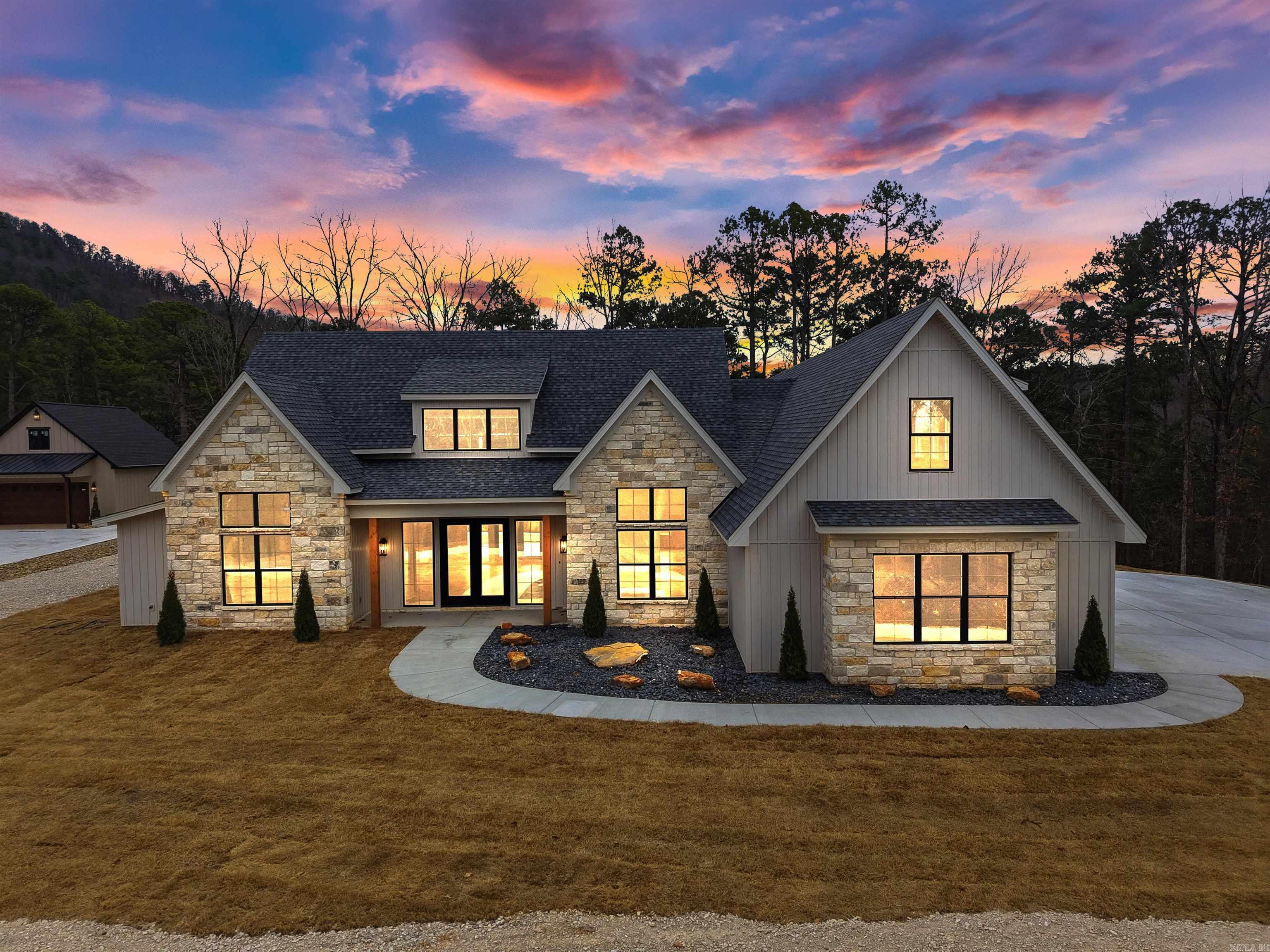 “If you have ever thought, I don’t want a vacation house…I want my own private resort. This is exactly what that would look like.” Welcome to 21 Southridge Dr in Mount Ida Arkansas - a true unicorn property built for escape. Not a cabin. Not a lake house. A place where weekends slow down the moment you arrive. Vaulted ceilings and exposed wood beams anchor the living room, instantly setting the tone. Natural light fills every space - you’re never cut off from the outdoors. The kitchen is made for hosting, highlighted by an oversized pantry you don’t see every day. 4 bedrooms, 3 full baths, 2 powder rooms give you room for everyone. Two hot water heaters keep everything running smoothly, even with a full house. Upstairs bonus flex room and a 3 car garage for weekend toys. On-site resort style maintenance and amenities, ownership stays easy. If your searching for a second home that feels like a retreat and not another obligation, you need to experience this in person.