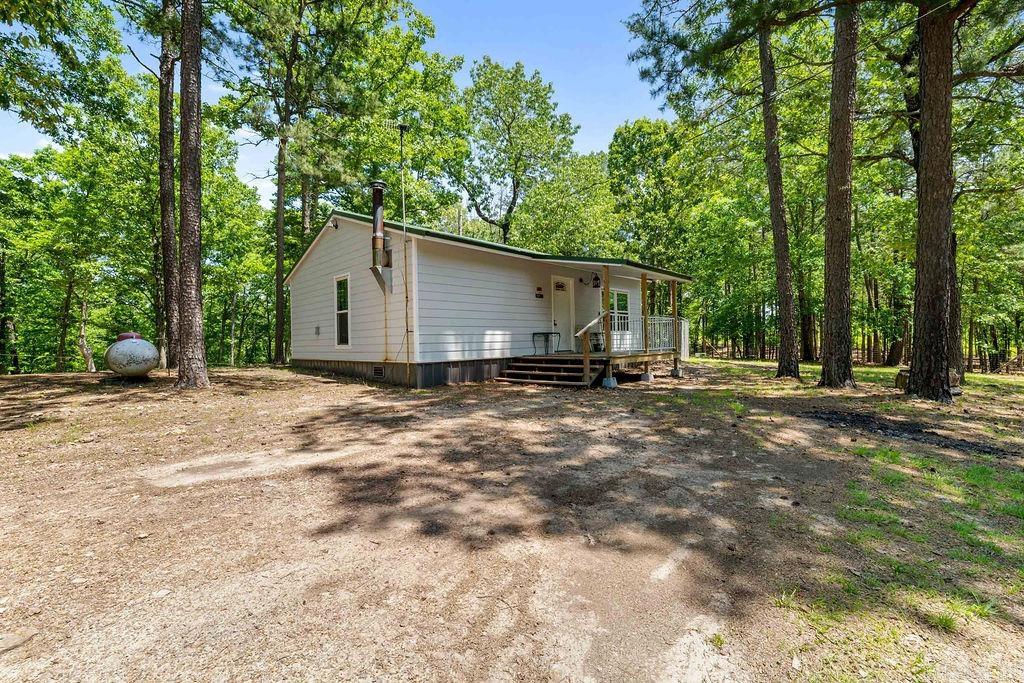 Nestled on approximately 7.21 peaceful acres, this charming furnished cabin offers a perfect blend of comfort and country living. The property features two well-built shop buildings—one measuring 14x18 and the other 10x16— one equipped with electricity and cooled for year-round use. A recent survey ensures clear boundaries and peace of mind. With access to both a private well and city water, the property is as practical as it is inviting. Outside, you’ll find a hog pen and a fenced area ideal for goats or other animals, providing plenty of space for small-scale farming or hobby livestock. This versatile retreat combines rustic serenity with modern conveniences, ready for you to enjoy from day one. Professional pictures coming soon.