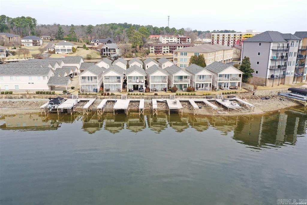 Experience coastal living at its finest in this beautifully updated waterfront stand-alone townhome, where modern upgrades meet serene water views and effortless outdoor living. Step inside to discover a light-filled interior featuring brand-new windows that frame the sparkling waterfront, luxury flooring throughout, fresh designer paint, and a newer roof for peace of mind. The fully renovated bathrooms showcase elegant finishes, contemporary fixtures, and spa-inspired details that create a true retreat. The open-concept living and dining areas flow seamlessly to a private waterfront patio — your front-row seat to breathtaking sunrises and tranquil evenings. Just steps away, your stationary boat slip sits right off the patio, making spontaneous sunset cruises and weekend adventures easier than ever.  Stand-alone townhome offering enhanced privacy.  Two-car carport with convenient covered parking. Direct access to a scenic boardwalk for morning strolls. Community pool perfect for relaxing or entertaining. Move-in ready with extensive upgrades throughout! A rare opportunity to own a fully updated waterfront retreat — where every day feels like a vacation.