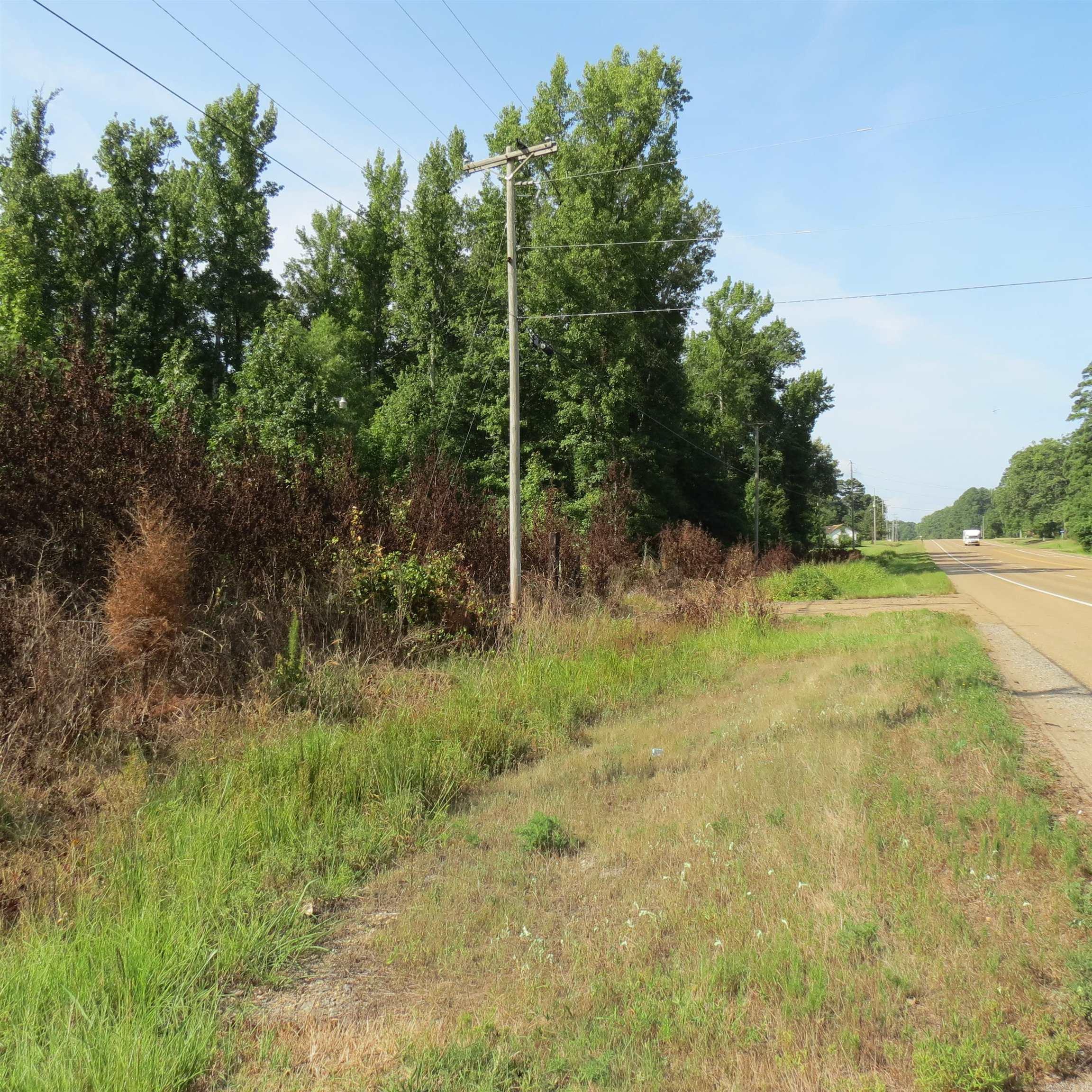 Discover the perfect blend of accessibility and seclusion with this 20.11 acre tract of land.  Ideally situated just 5 miles South of I530, short distance from the convenience of town.  This property offers the ultimate canvas for your vision.  Highway frontage gives excellent visibility and easy access for residential, recreational, hobby farm or potential commercial development. This land is wooded, with timber and has a pond.  There was a mobile home there at one time years ago.  There is a pole barn.  Call today for more information.