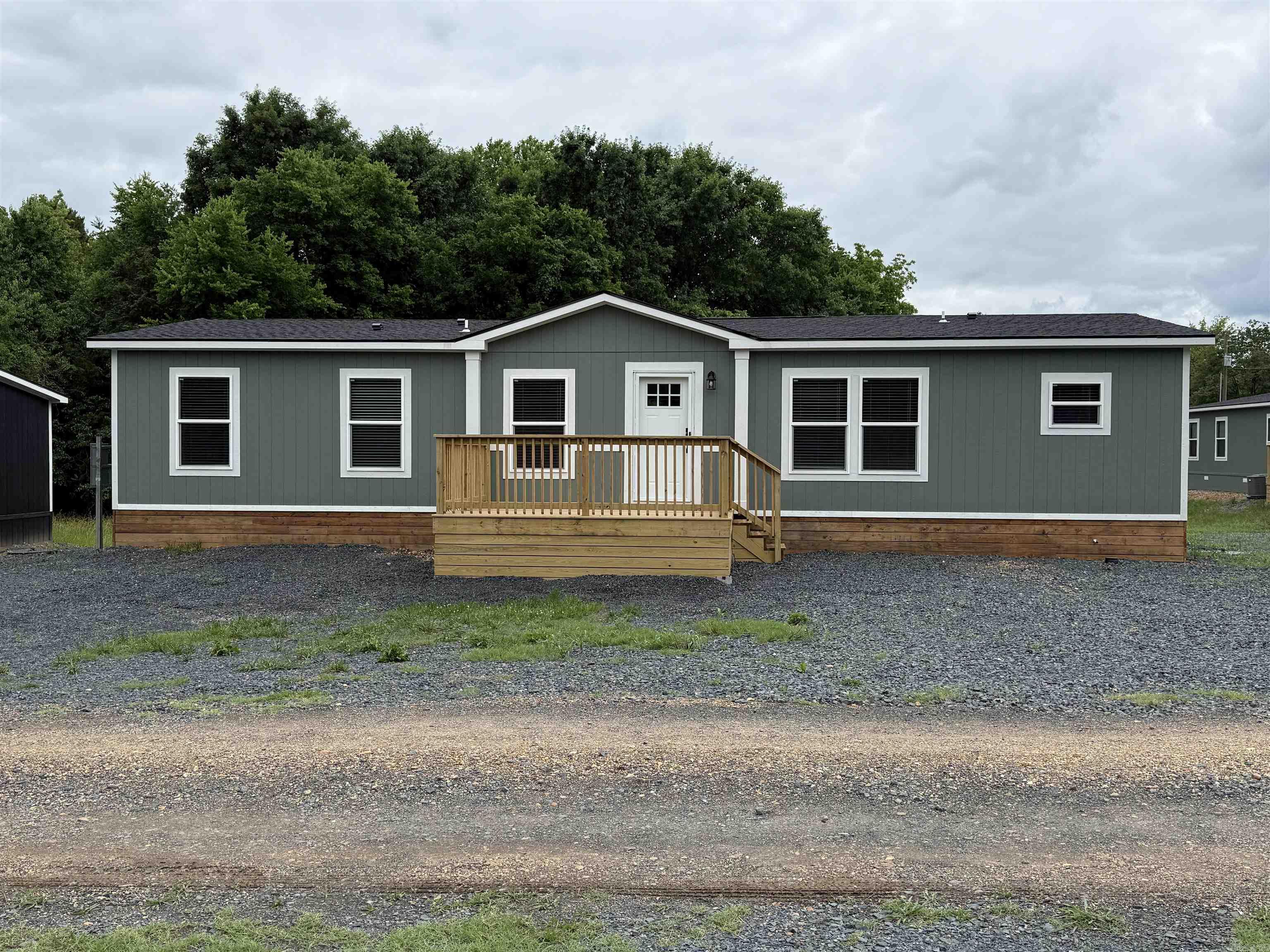 2025 3-bedroom, 2-bathroom manufactured home with approximately 1,568 sq ft, featuring warm farmhouse finishes and a bright, inviting interior. This thoughtfully designed open floor plan offers a spacious living area, oversized kitchen island, stainless steel appliances, light cabinetry, and natural wood-tone accents throughout. The split-bedroom layout includes a private primary suite with a walk-in closet and an ensuite bath. Modern lighting, neutral colors, and comfortable living spaces make this home feel both stylish and welcoming. Permanently affixed to the ground on a concrete slab, making it eligible for government financing per engineering certification requirements. Brand new and move-in ready!  See documents on file for a copy of the Energy Star Certification.