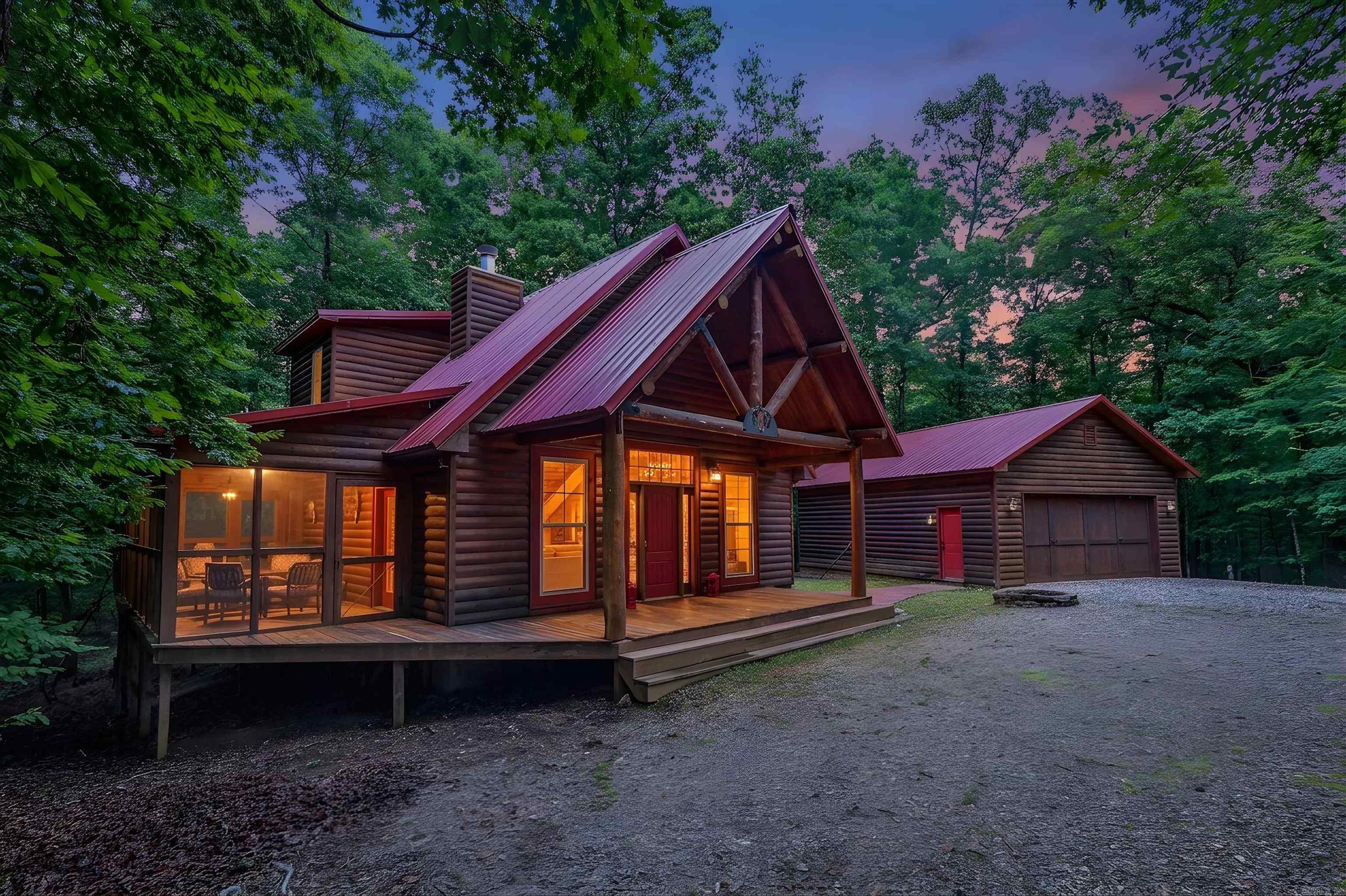 Custom-built log home just minutes from beautiful Lake Ouachita! This 2-bedroom, 2-bath home offers approximately 1,072 square feet of rustic charm, quality craftsmanship, and a prime location in the heart of Montgomery County. Built by the seller using real logs, including wood reclaimed from a 150-year-old barn, this one-of-a-kind property is filled with character and warmth.  Inside, you'll find a cozy living area anchored by a wood-burning fireplace, while the kitchen features a unique blend of granite, marble, and quartz countertops. In addition to the two bedrooms, the home includes a bonus room currently used as a bunk room that would make an excellent office, hobby room, guest space, or flex room to fit your needs. The primary suite offers a Jacuzzi tub and private deck, creating the perfect place to unwind. Additional features include an instant water heater, all-electric utilities, screened-in porch, and washer and dryer that convey with the home.  The detached garage provides exceptional flexibility with a kitchenette, full bathroom, and washer/dryer hookups, making it ideal for guests, a workshop, hobby space, or potential additional living quarters. Two wet-weather cre