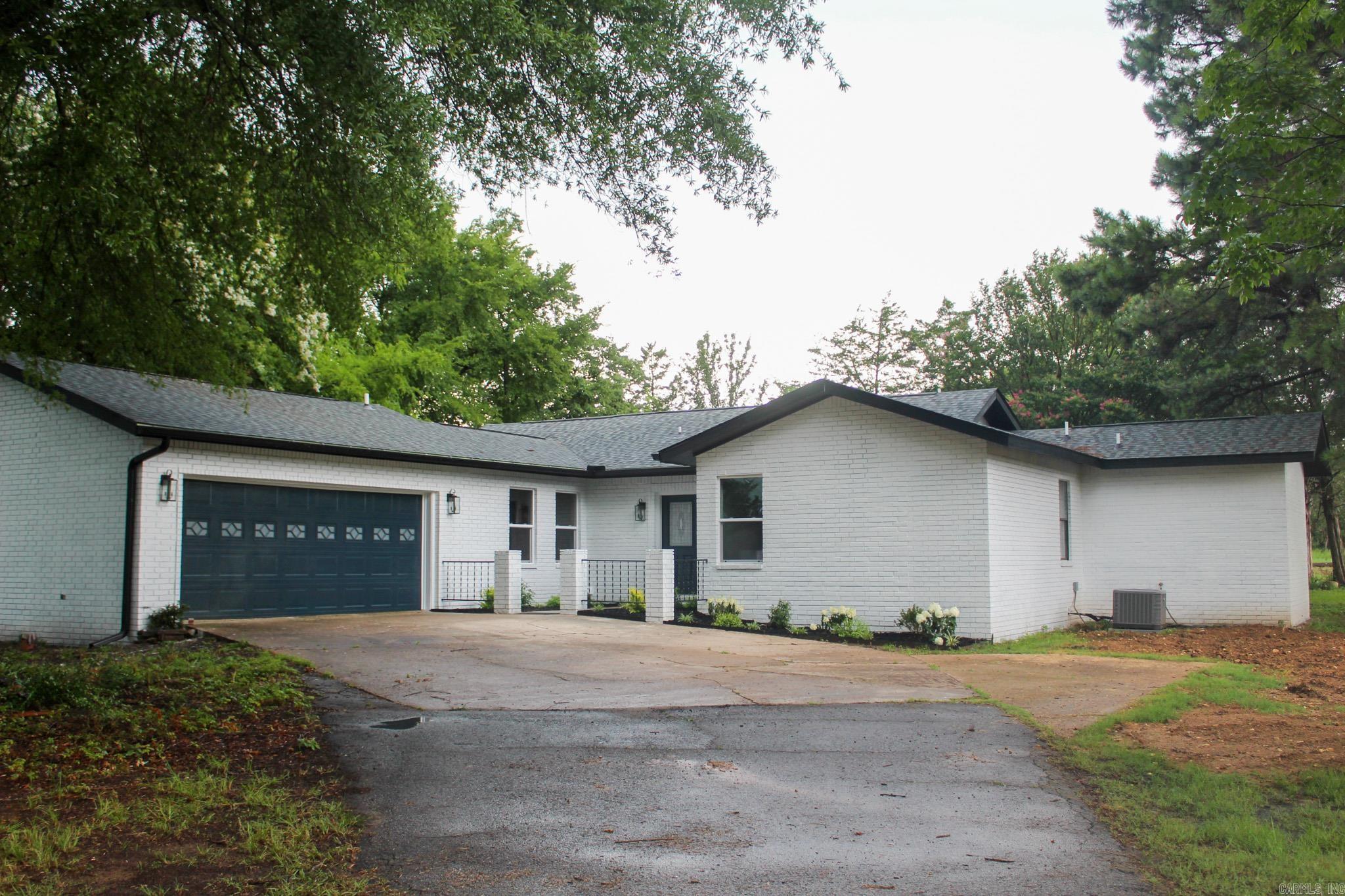 Welcome to this beautifully remodeled home located in Searcy! This property perfectly combines modern updates with comfortable living, creating a fresh and inviting atmosphere. The interior features fresh paint and new flooring throughout. The kitchen is equipped with brand new stainless steel appliances, making cooking a delight. The spacious master suite includes a thoughtfully added master bedroom and bathroom, featuring a large tiled walk-in shower, a roomy walk-in closet with ample storage, and a full-length mirror. The exterior showcases a rejuvenated look with a new roof and fresh paint, enhancing its contemporary curb appeal. The updated landscaping adds to the home’s exterior beauty. The backyard is an oasis with a new back deck and an updated back patio, featuring stained tongue and groove and new ceiling fans for relaxation. Additional features include a 3 year old HVAC system. The home sits on a 2.6-acre lot, offering plenty of space for outdoor activities and privacy. This move-in-ready home is waiting for its new owners. With its numerous updates and convenient location, it’s a must-see for anyone looking to settle down in Searcy!