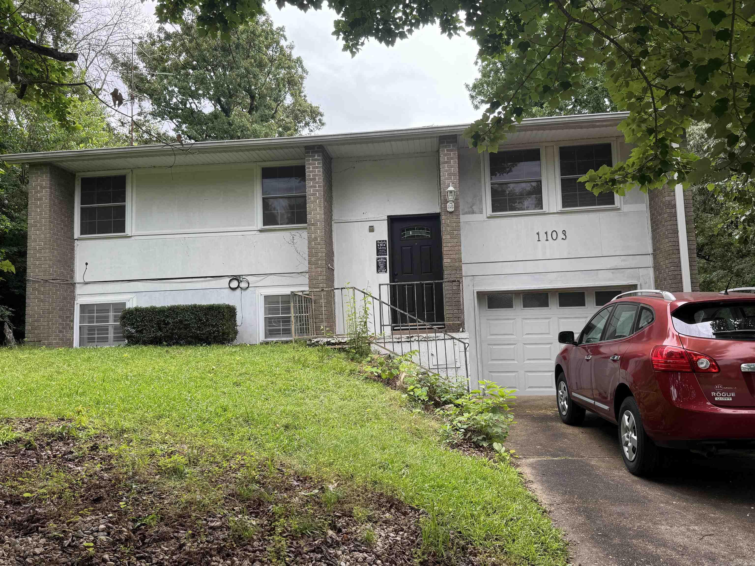 This spacious 2,246-square-foot split-level home offers 4 bedrooms and 2 full bathrooms with a functional layout designed for comfortable living. The main level features a welcoming living room and an open-concept kitchen and family room with wood burning fireplace and built-ins, creating an ideal space for everyday living and entertaining.  Three bedrooms are conveniently located on the upper level, while the private primary suite is situated downstairs and includes a separate sitting room, providing a relaxing retreat. Outdoor living is enhanced by a screened-in porch and adjoining deck, perfect for enjoying the outdoors year-round.  Additional features include a single-car garage and a basement, offering ample storage and flexible space for hobbies or recreation. This well-designed home combines space, comfort, and versatility in a desirable split-level floor plan.