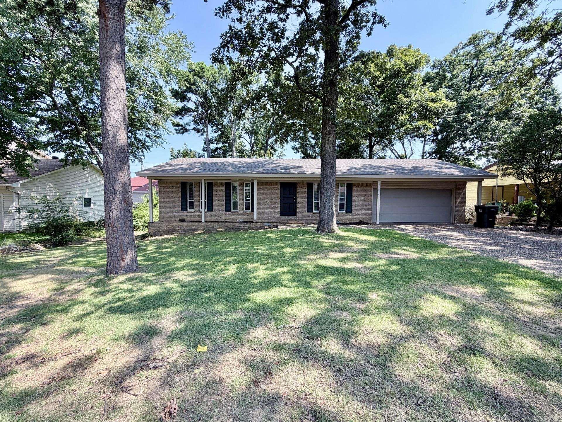 Welcome home to this beautifully updated property in the heart of West Little Rock. Conveniently located near shopping, dining, and everyday amenities, this home also offers a private backyard retreat that truly sets it apart.  Featuring three bedrooms and one and a half baths, this home has been thoughtfully updated with new flooring, modern lighting, fresh paint, and renovated bathrooms. The open floor plan creates a comfortable and functional living space, perfect for both everyday living and entertaining.  Step outside to your own backyard oasis, where the property backs up to peaceful green space, offering added privacy. The oversized deck is ideal for hosting gatherings or simply relaxing and enjoying the natural surroundings.  Additional highlights include a two-car garage, a brand-new roof, and a newer HVAC system—providing peace of mind and low maintenance for years to come. This home is truly move-in ready and waiting for its next owner