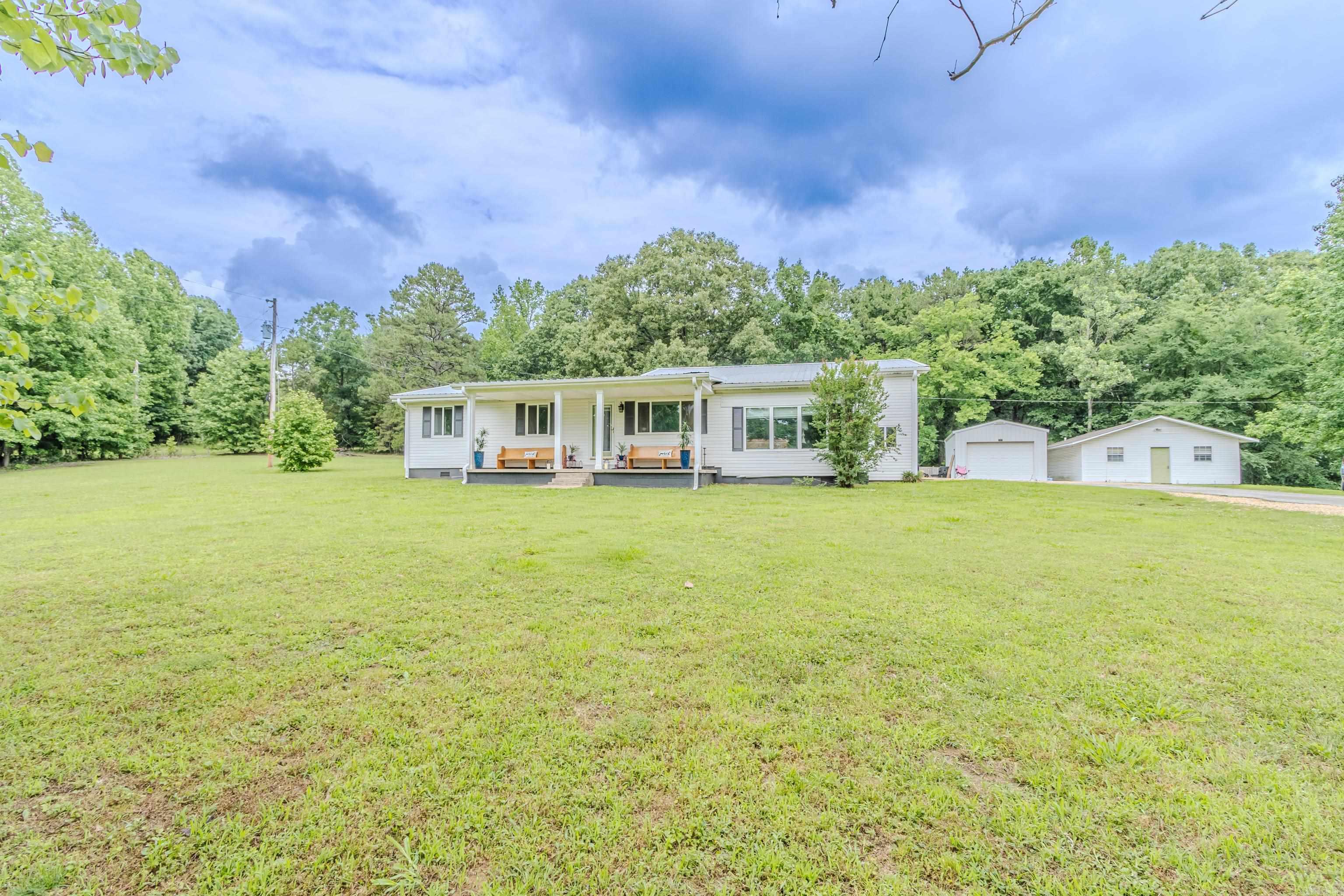 Situated on 6.87 +/- acres just west of Paragould, this property offers space, privacy, and plenty of room to spread out. The main home features 3 bedrooms, 2.5 bathrooms, a formal dining room, and a large primary suite designed for comfort and relaxation. Outside, you’ll find a separate 1,600 sq ft shop offering ample storage and workspace. An additional 864 sq ft apartment includes 2 bedrooms and 1 bathroom, providing extra living space for guests or family. There is also a separate 20x26 shop located on the property. With beautiful acreage and multiple improvements, this property combines peaceful country living with the convenience of being just minutes from town.
