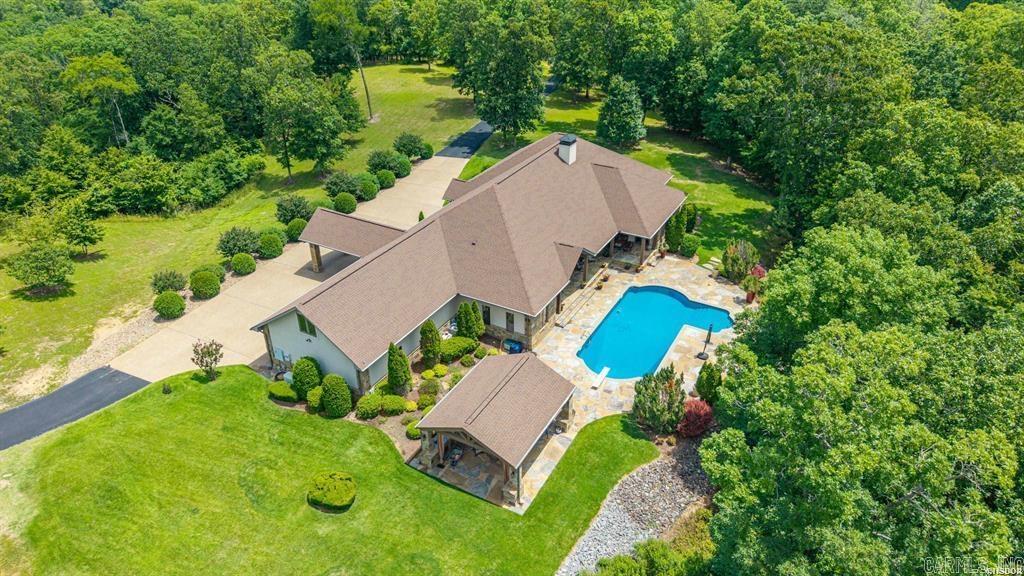 Encompassing approximately 4,840 square feet, the residence showcases timeless craftsmanship, quality finishes, and well-designed living spaces tailored for both everyday comfort and sophisticated entertaining. From the moment you enter the property, the beautifully maintained grounds and fully paved driveway create a striking first impression that continues throughout the estate.  At the center of the home is the chef-inspired kitchen, designed to accommodate both casual living and large gatherings. This impressive space features high-end appliances, a gas cooktop, abundant custom cabinetry, an oversized walk-in pantry, and a large center island with prep sink and breakfast bar seating.  The home features three spacious bedrooms, each thoughtfully designed with its own private en-suite bathroom.  Spacious living areas are featured throughout the home, including a generously sized main living room and an additional den for added flexibility. The home office is perfect for your business needs and could also be used as a workout or craft room. Additional features include energy-efficient geothermal heating and a whole-home generator, ensuring year-round comfort and reliability.